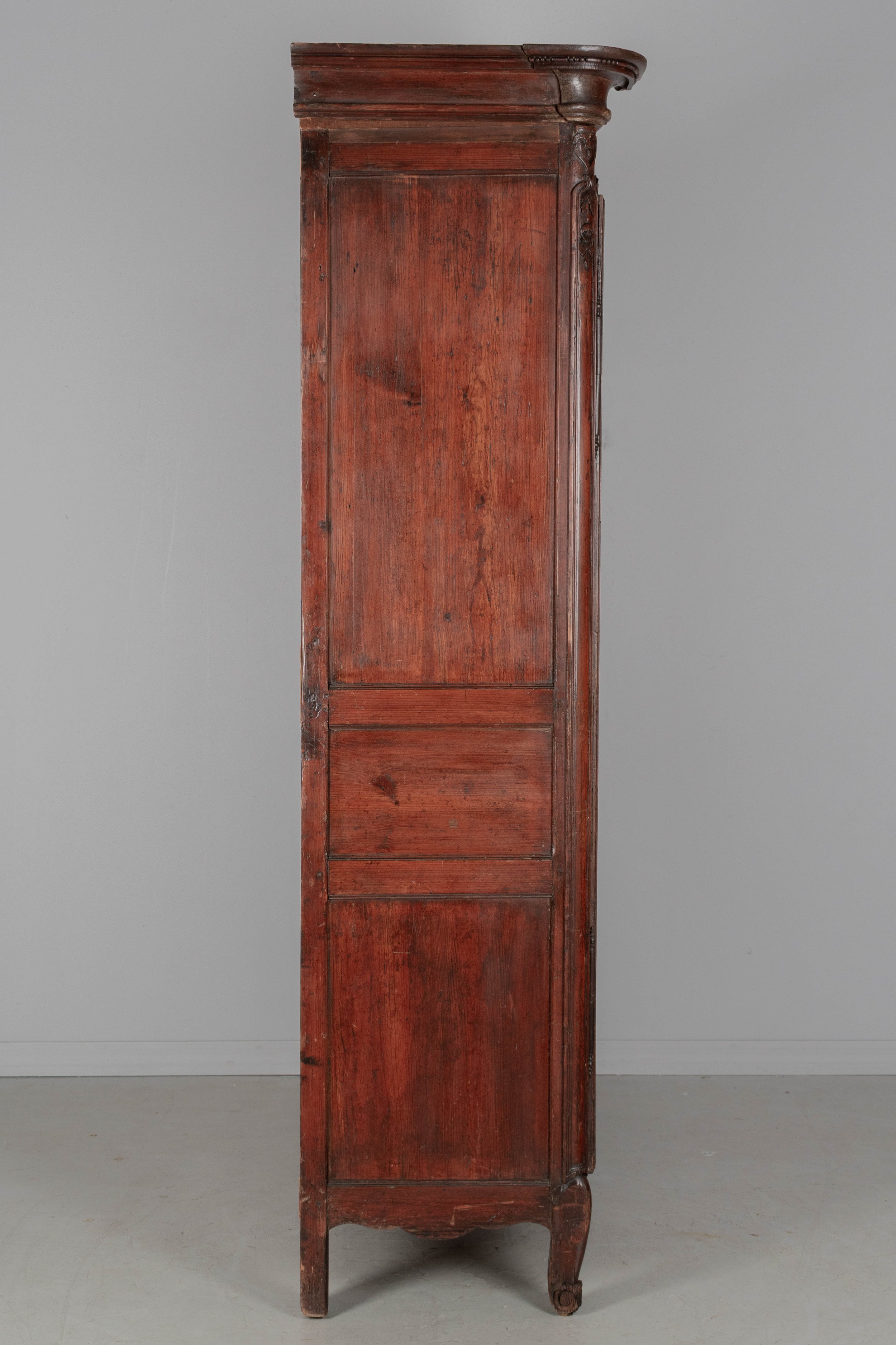 An early 19th century Louis XV country French bridal armoire from Normandy.