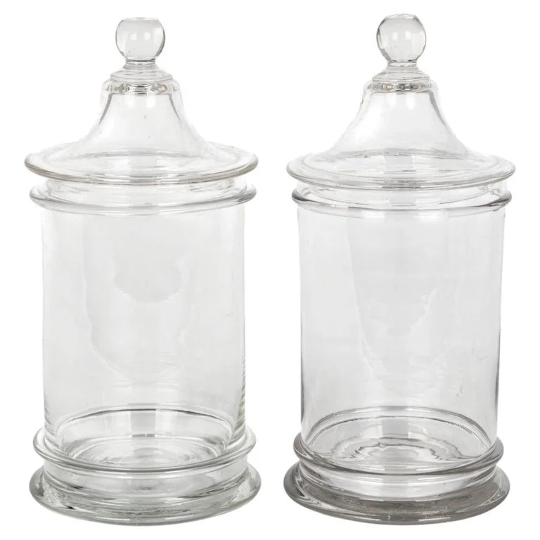 A pair of French hand-blown clear glass lidded apothecary or candy jars