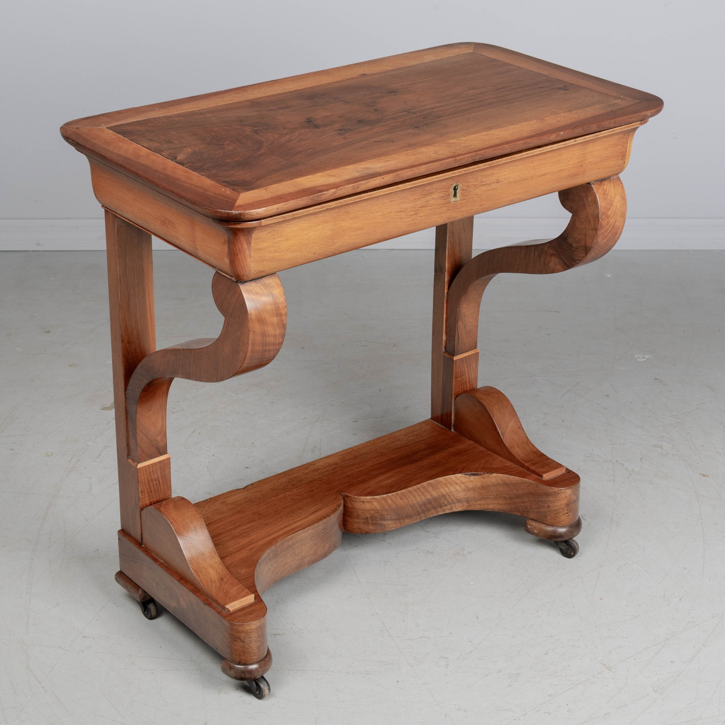 A 19th century French Louis-Philippe console made of solid walnut and veneer of walnut