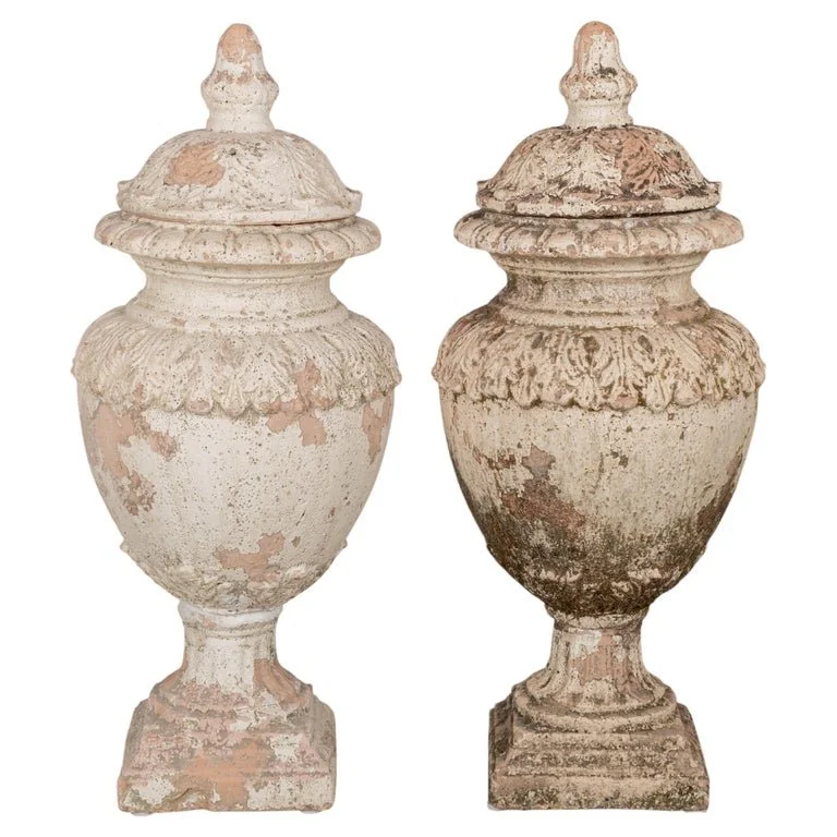 A pair of French terracotta garden urns with lids. Classical vase form on pedestal base, decorated in acanthus leaf motif with large acorn finials on lids.
