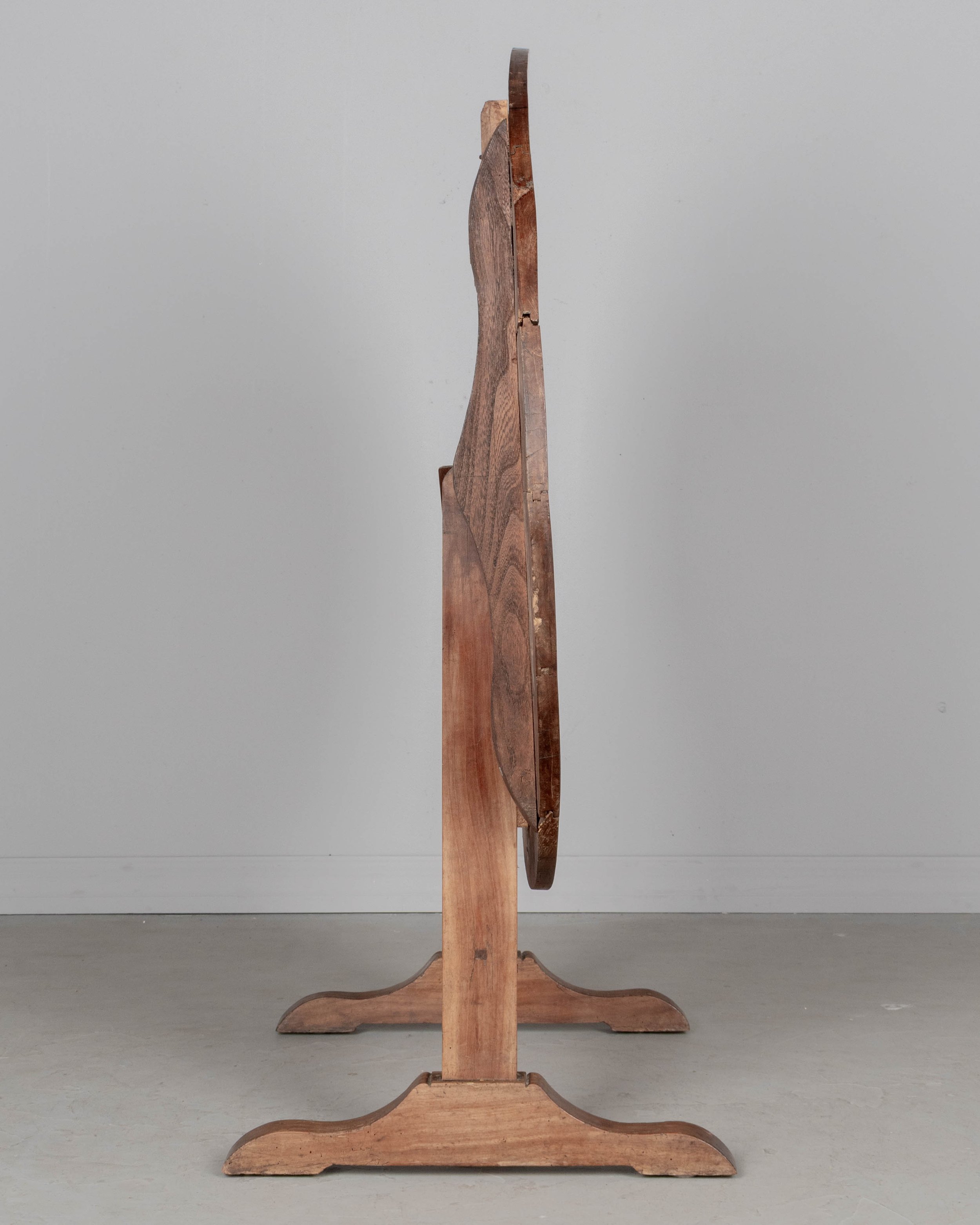 French oval wine tasting, or tilt-top table made of solid cherry.