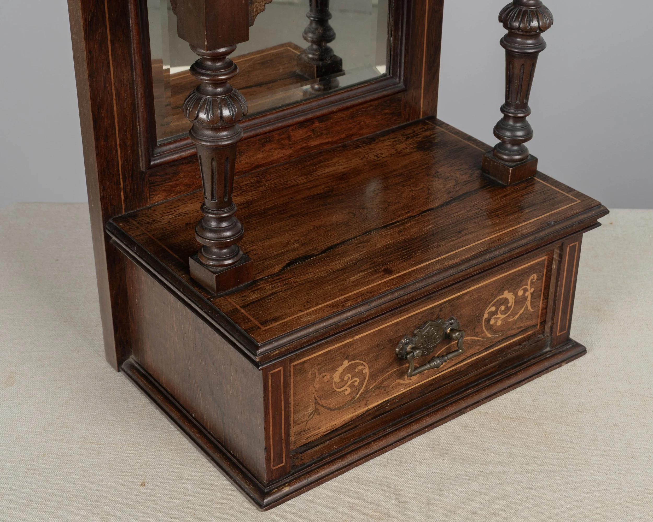A 19th century English Edwardian vitrine constructed using rich, finely grained rosewood with contrasting satinwood marquetry.