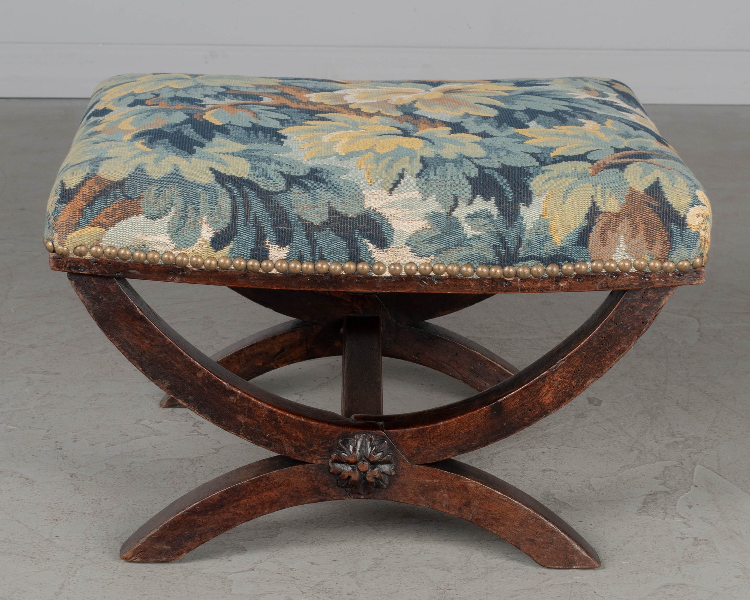 A small 19th century Louis XIII style stool with solid walnut frame and carved medallion detail