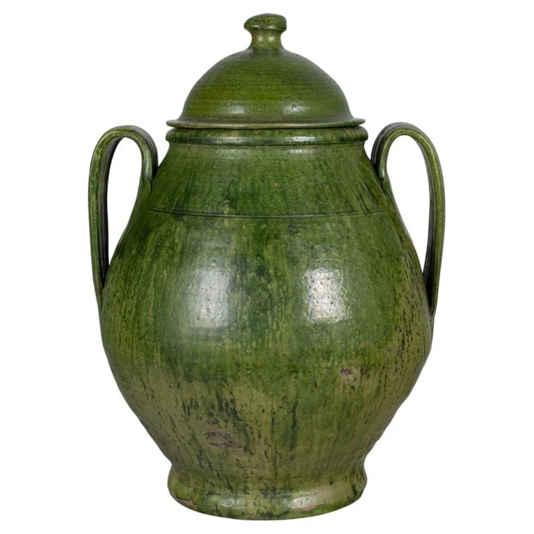 A large green glazed earthenware lidded jar made in Portugal