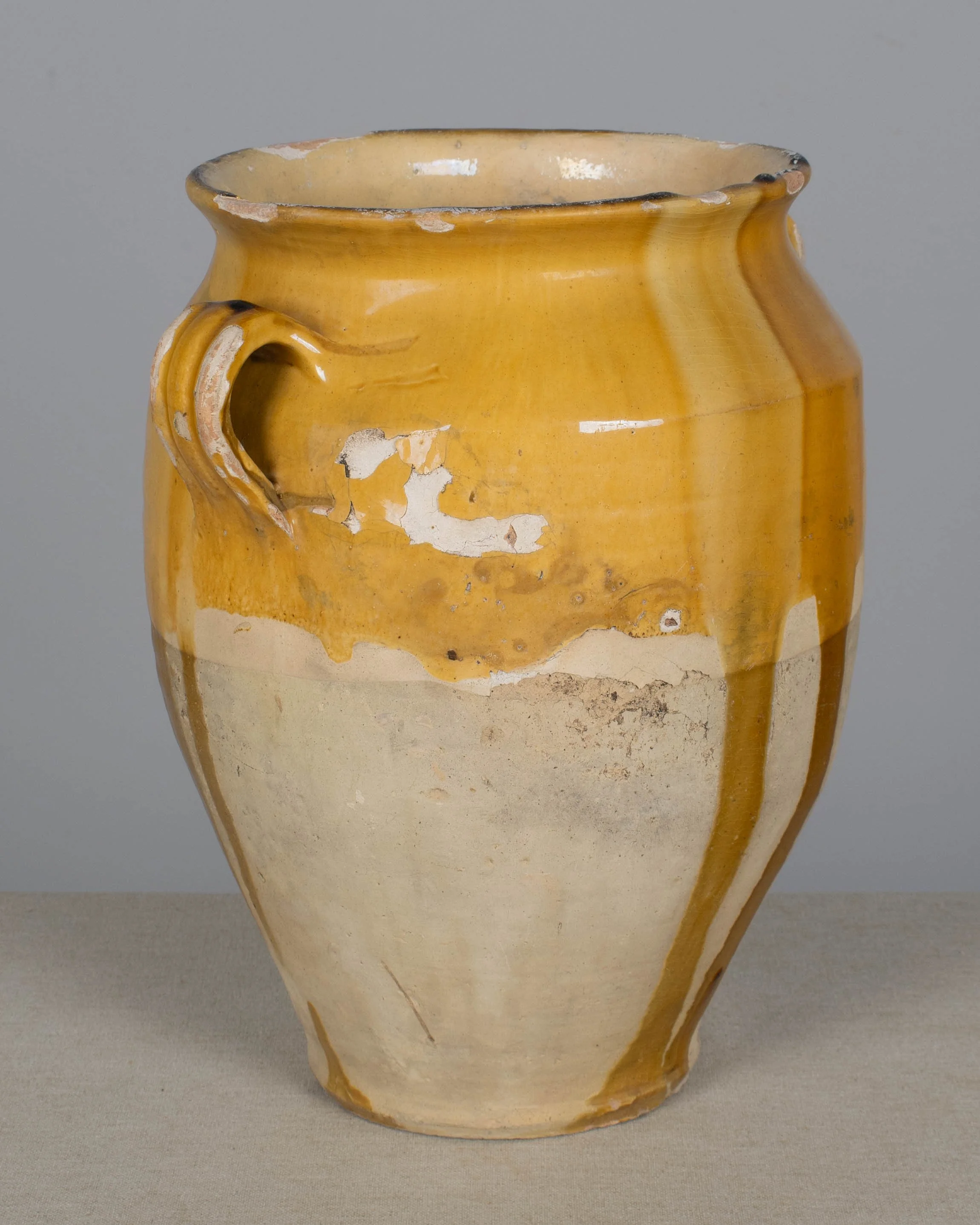 An earthenware confit pot from the Southwest of France with traditional yellow ochre drip glaze.