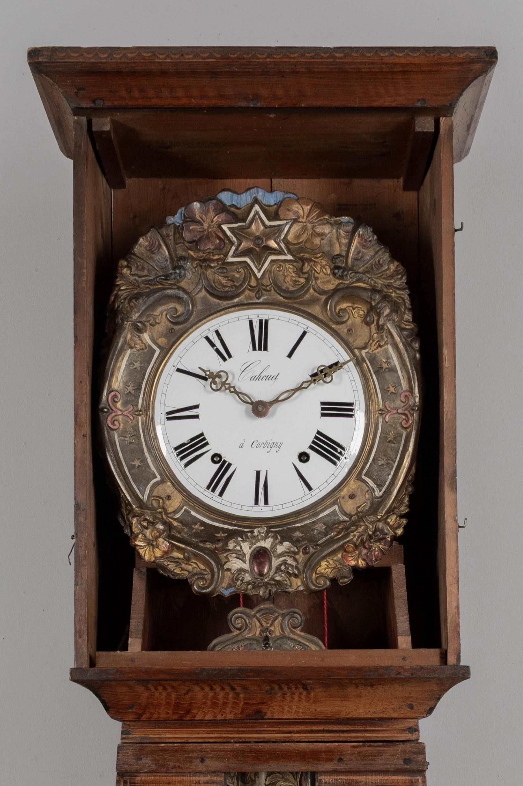 19th century Country French comtoise, or grandfather clock, with polychrome painted pine case and embossed brass pendulum.
