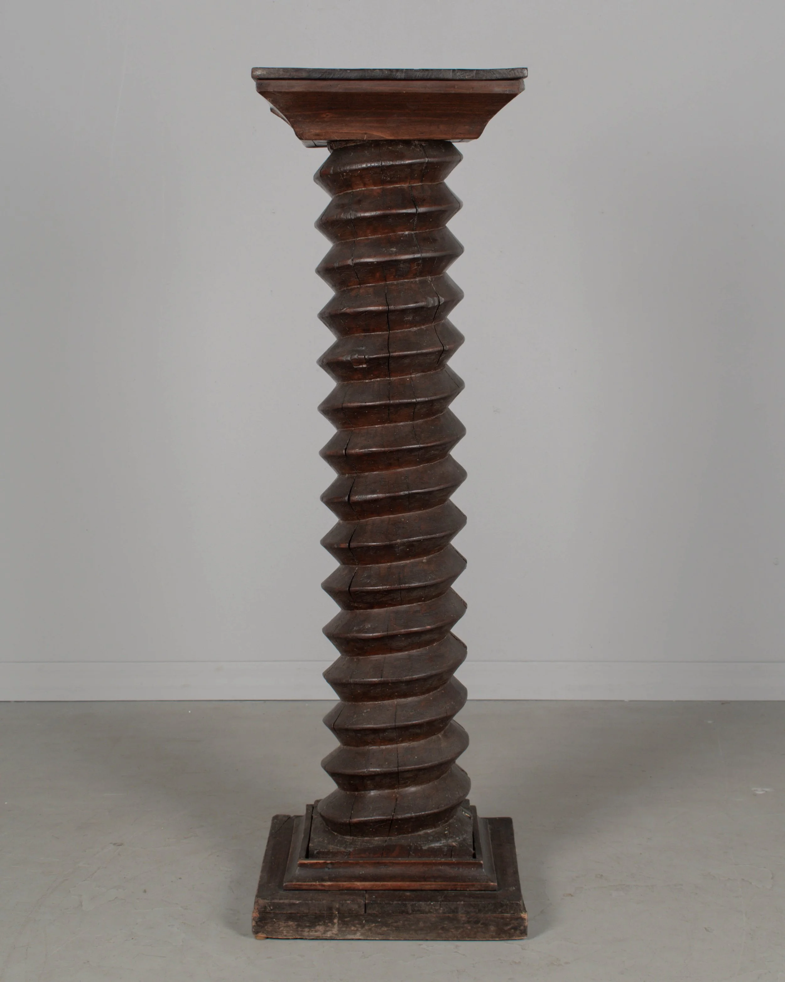 A late 18th century French wooden wine press screw, repurposed as a pedestal or plant stand