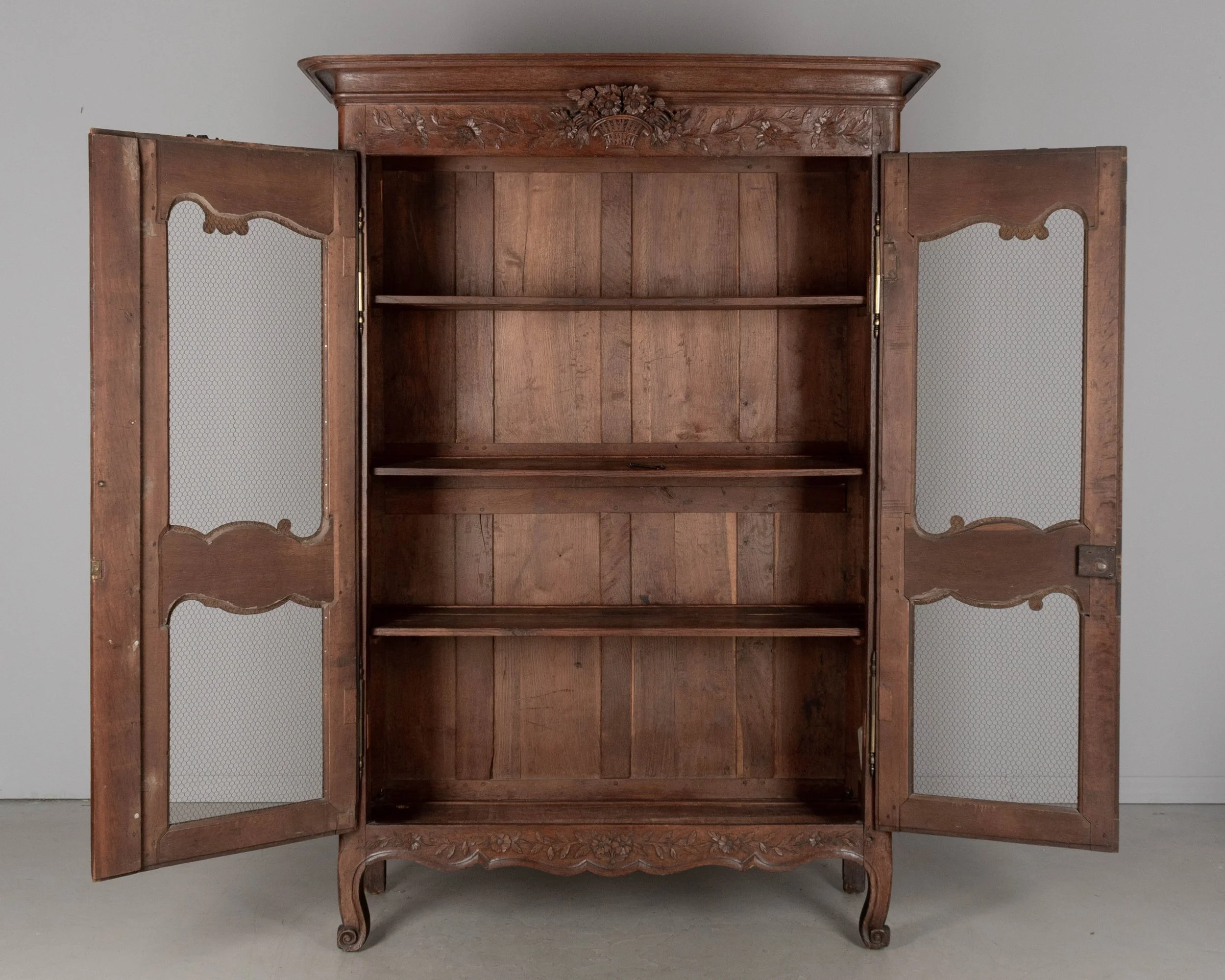 A 19th century Louis XV style Country French armoire, or display cabinet from Normandy.