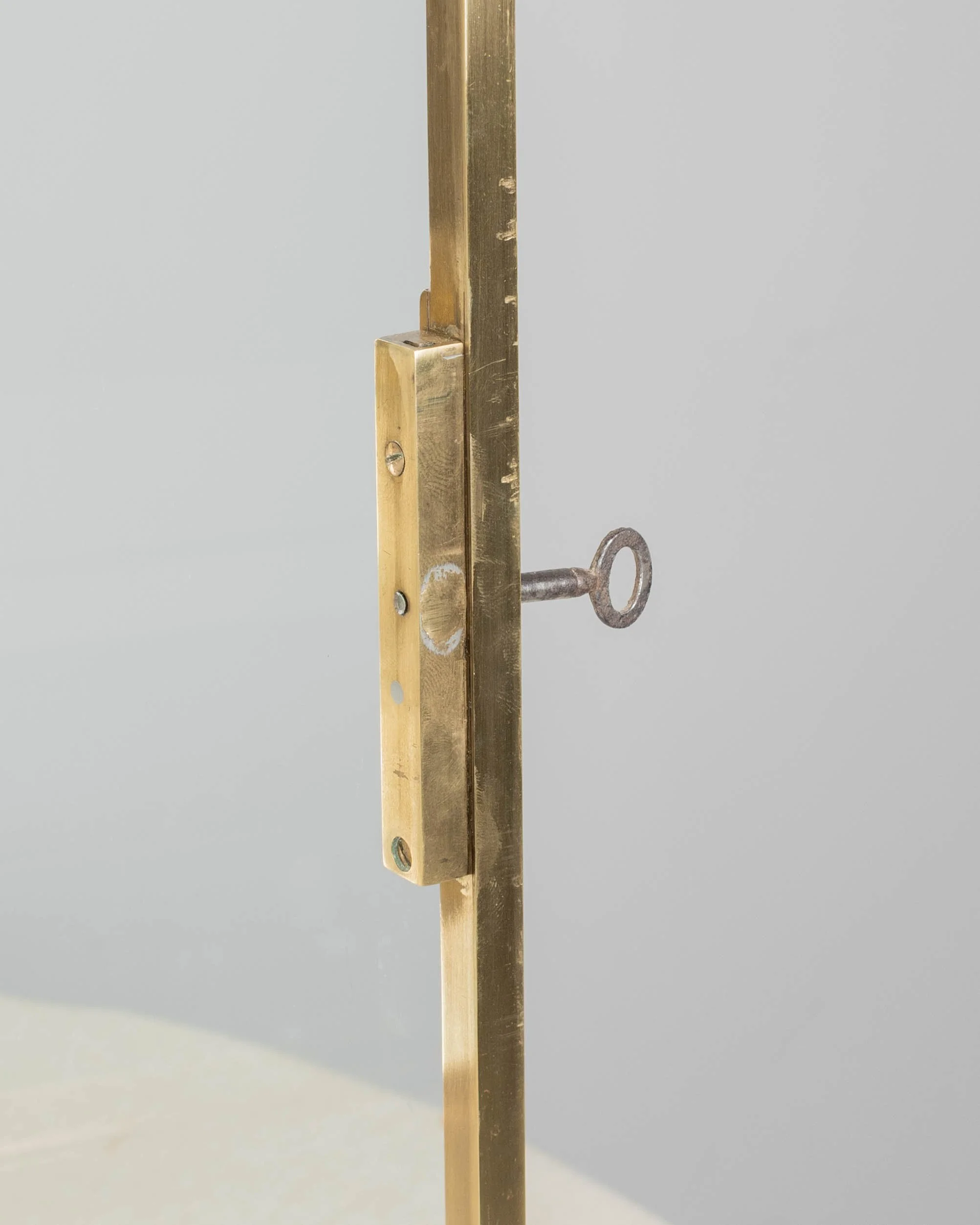 A French Art Deco hanging wall vitrine with solid brass frame, mirrored back and glass panes.