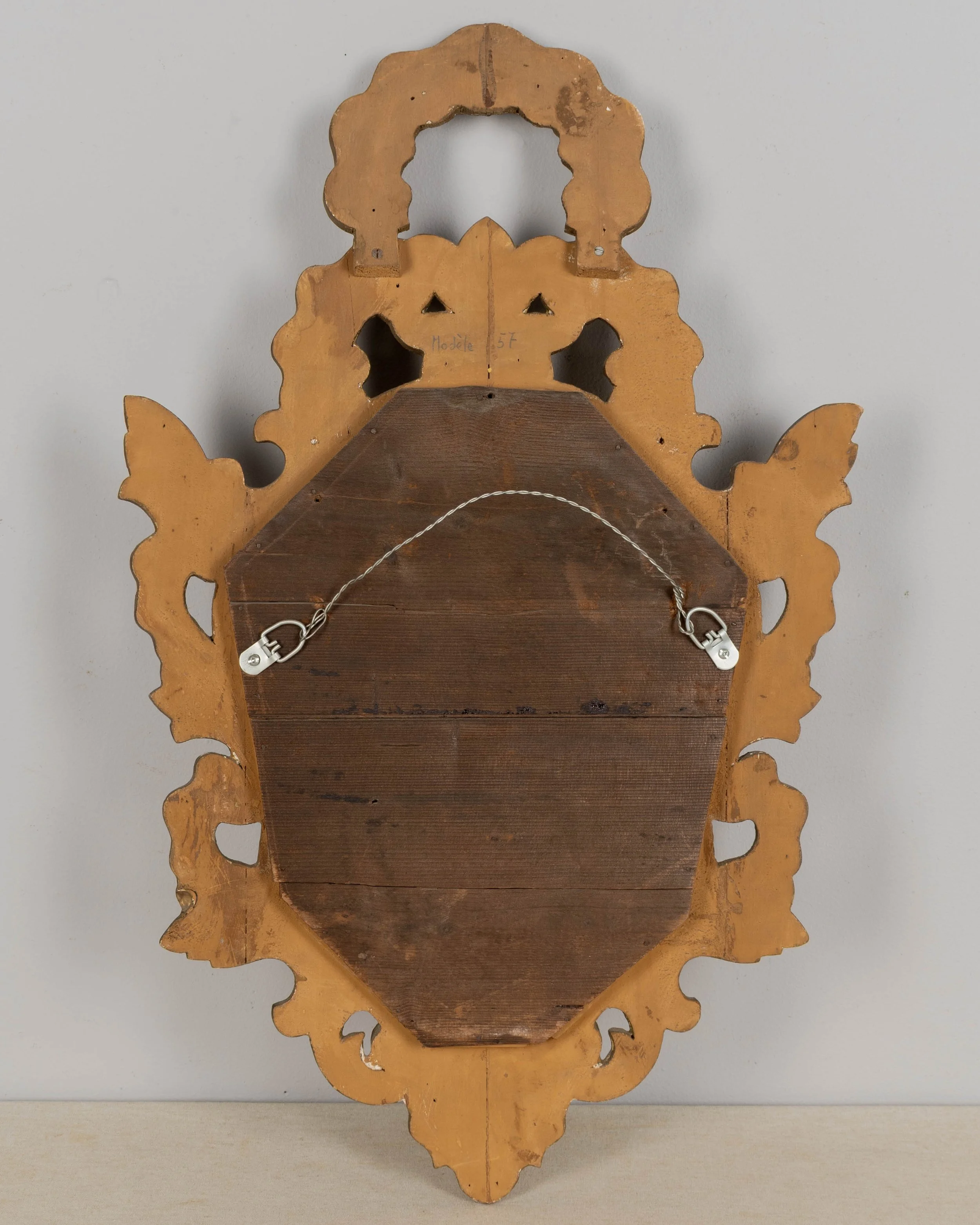French Baroque style giltwood mirror with cartouche shape framed by undulating borders.