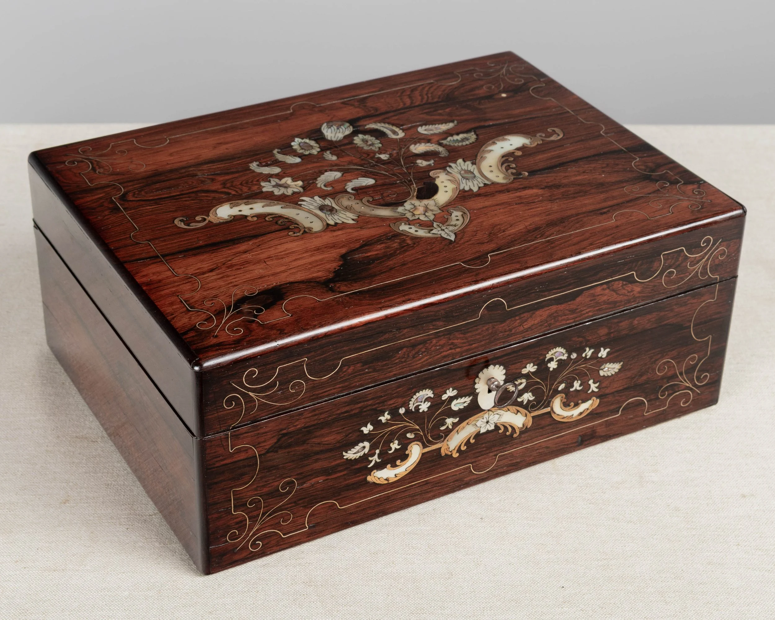 A 19th Century French Napoleon III marquetry box made of rosewood veneer with fine mother-of-pearl and brass inlay.