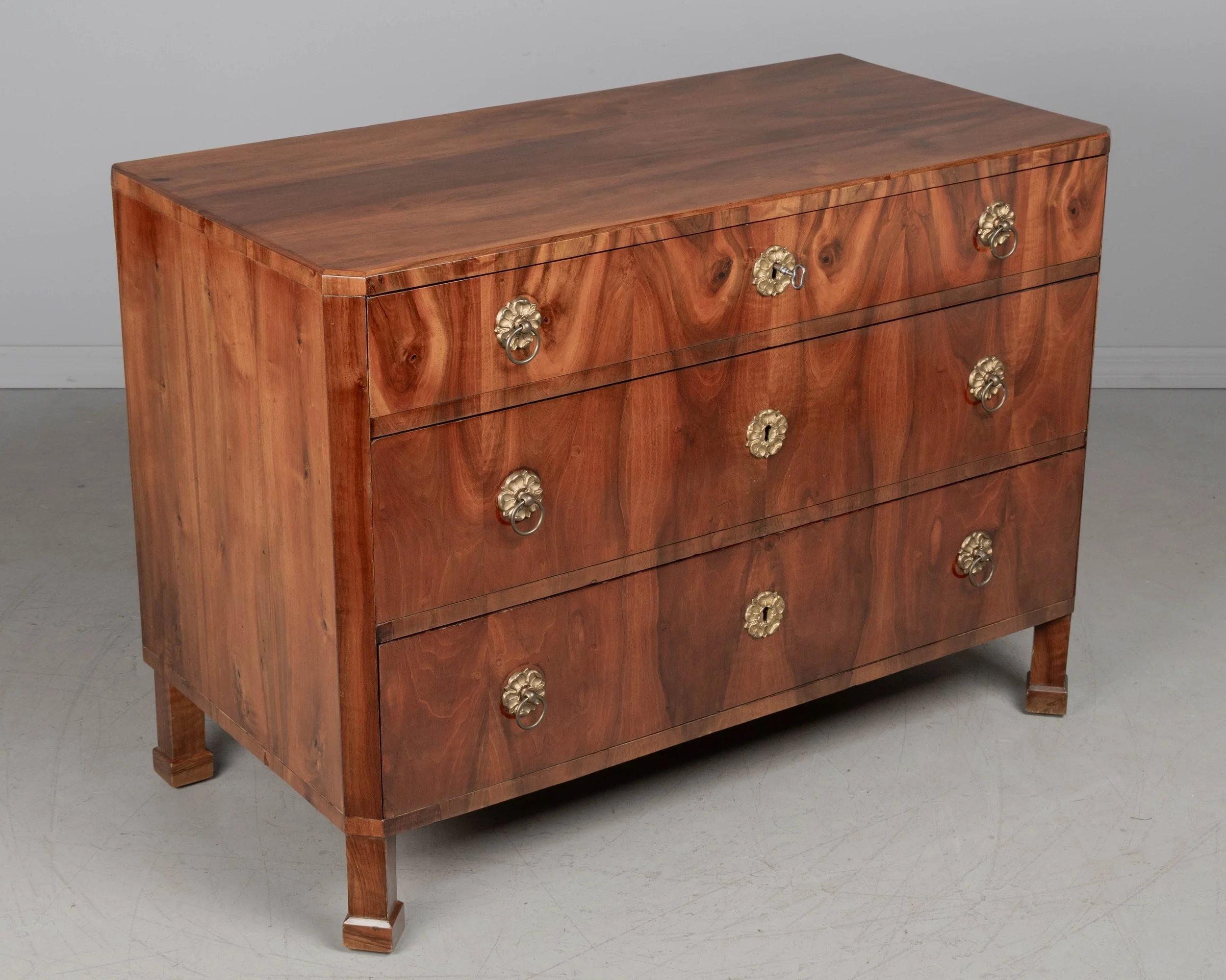 A fine 19th century Biedermeier commode from Austria made with beautifully patterned book matched veneer of walnut over pine.