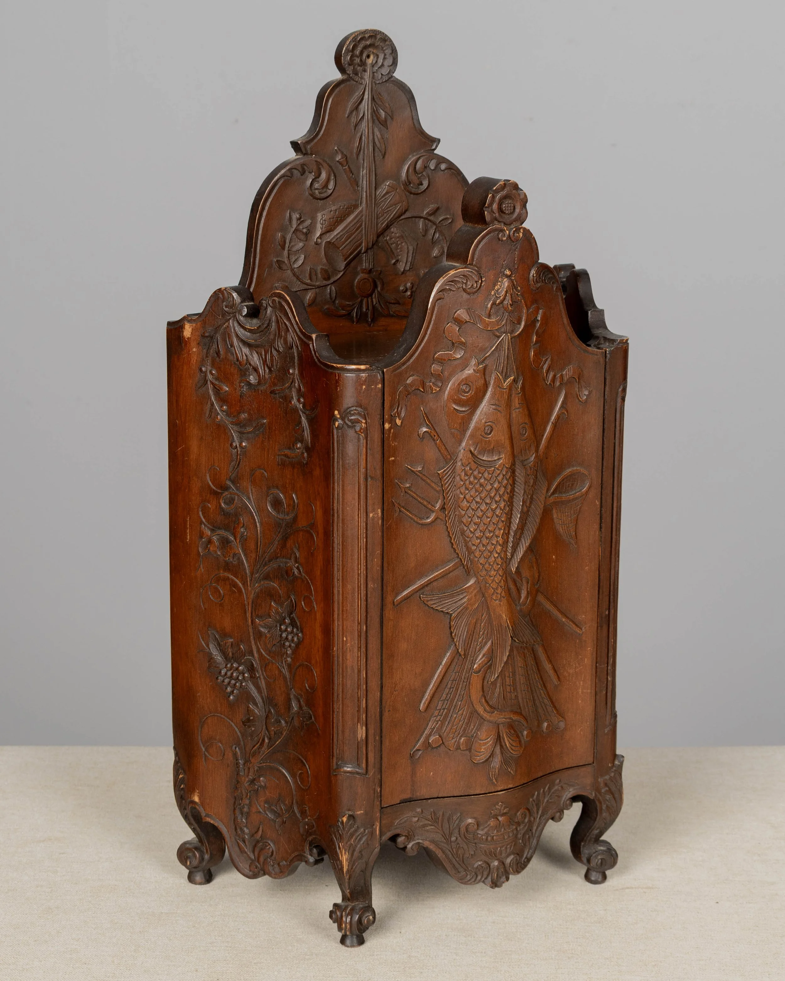 19th century French fariniere made of walnut with nicely detailed hand-carved decorative motifs: