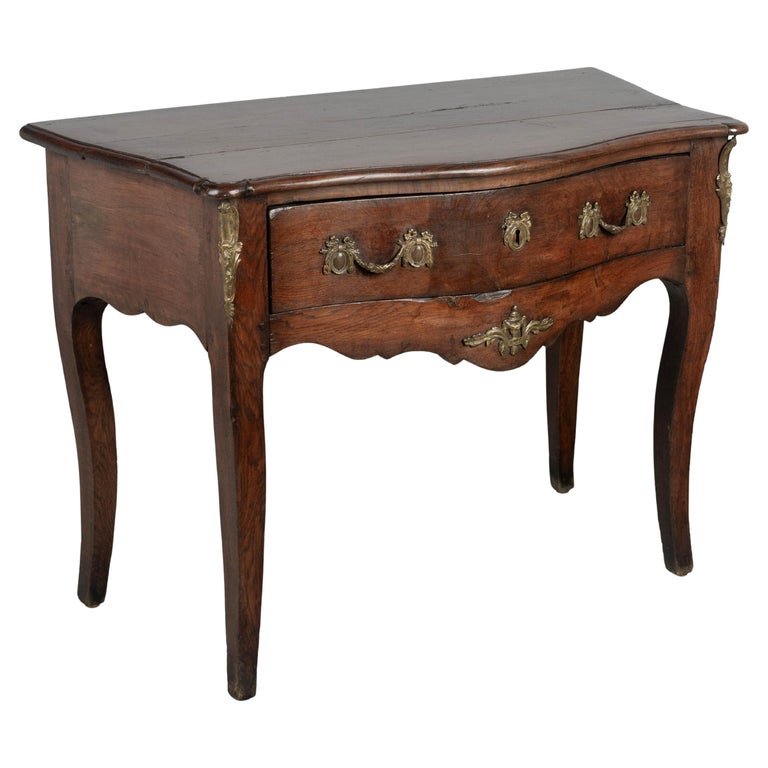 An 18th century Louis XV style French Provençal console table with serpentine front,