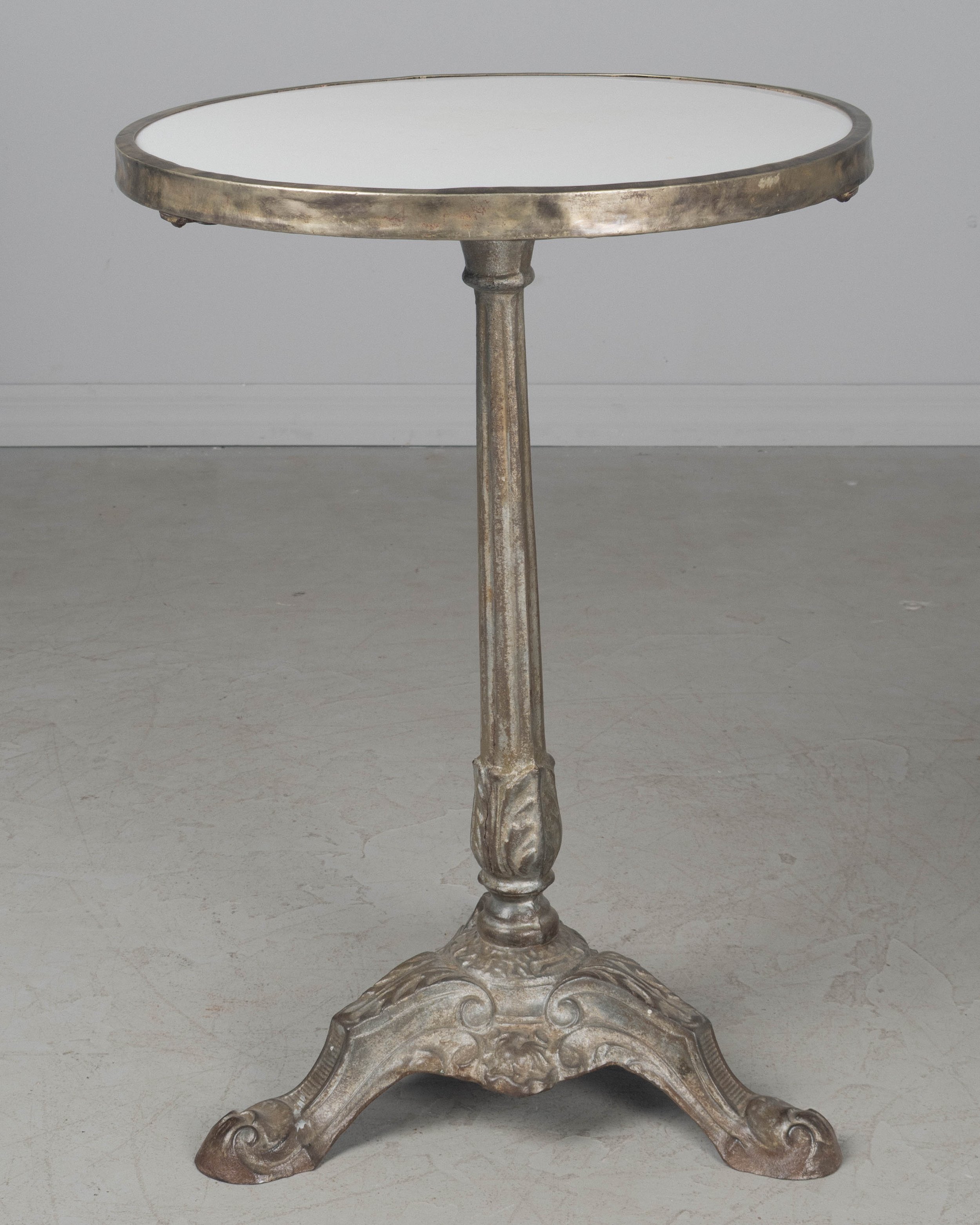 A 19th century French cast iron bistro table with pedestal base.