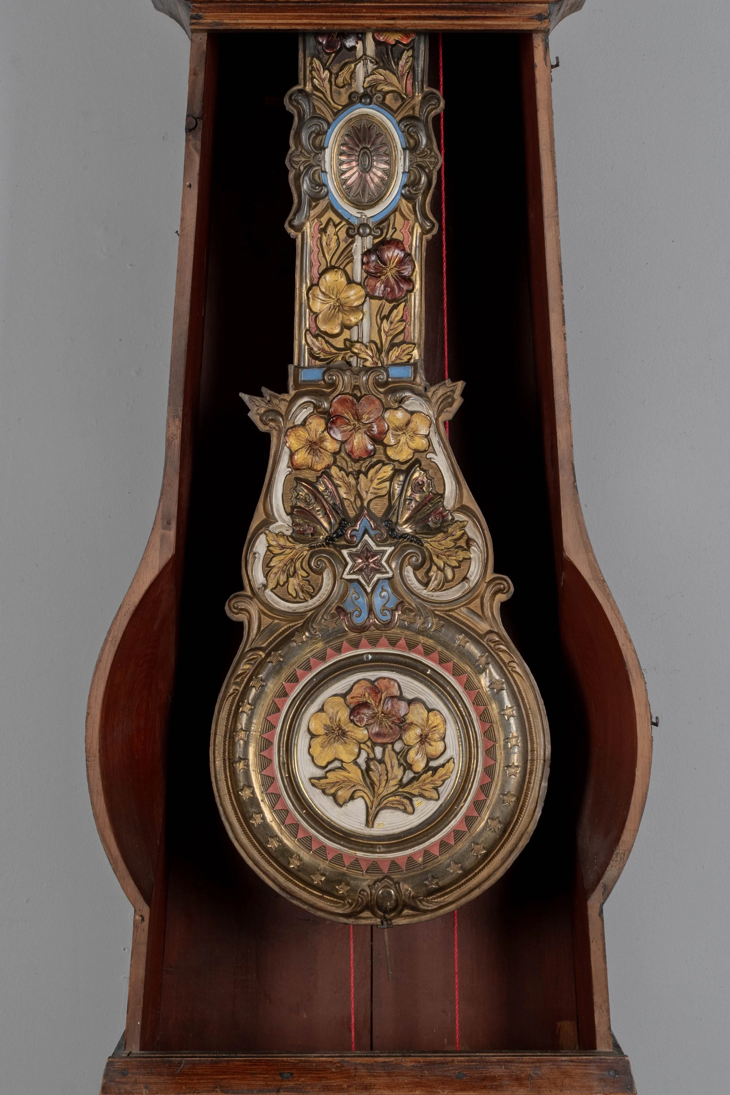 19th century Country French comtoise, or grandfather clock, with polychrome painted pine case and embossed brass pendulum.