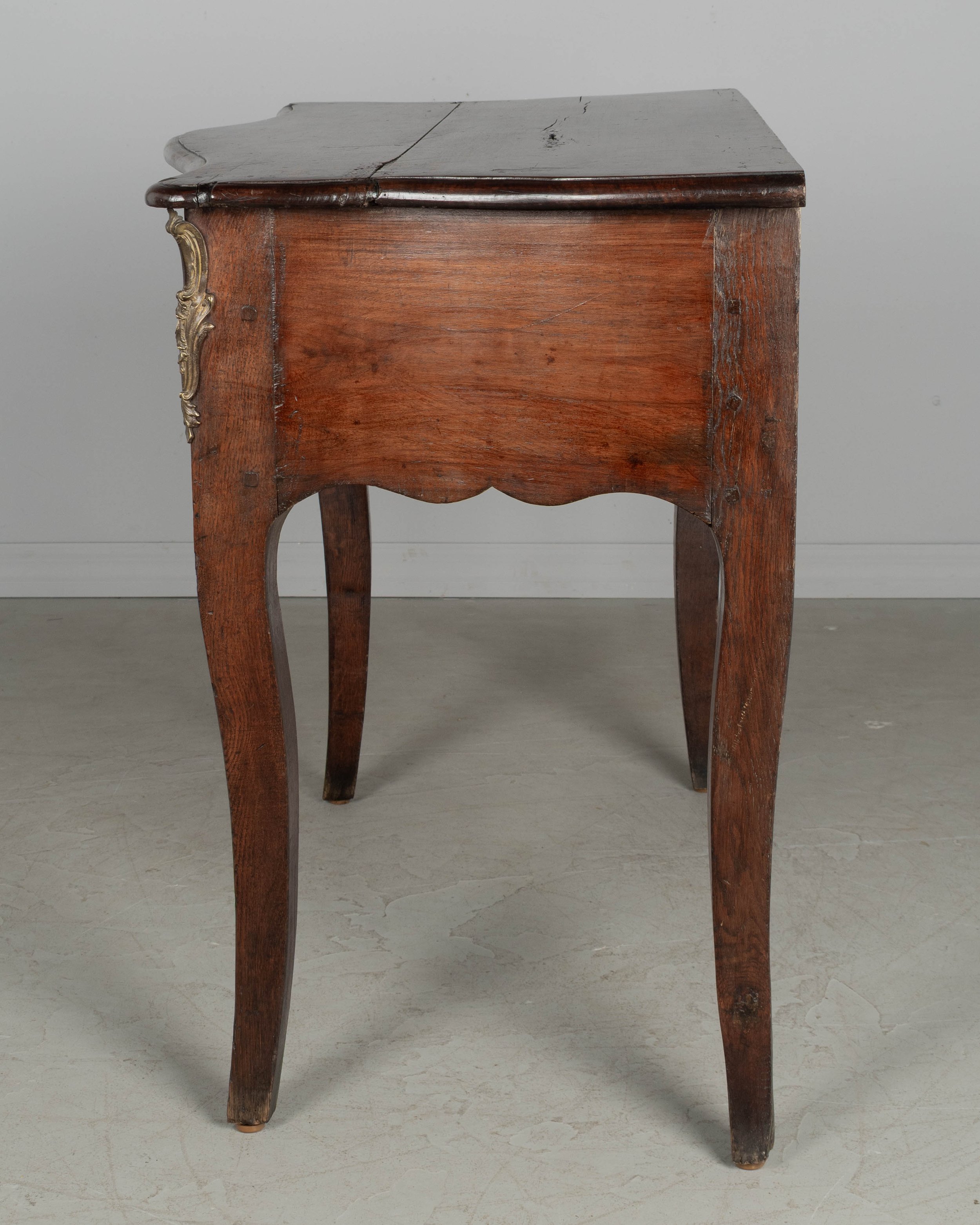 An 18th century Louis XV style French Provençal console table with serpentine front,