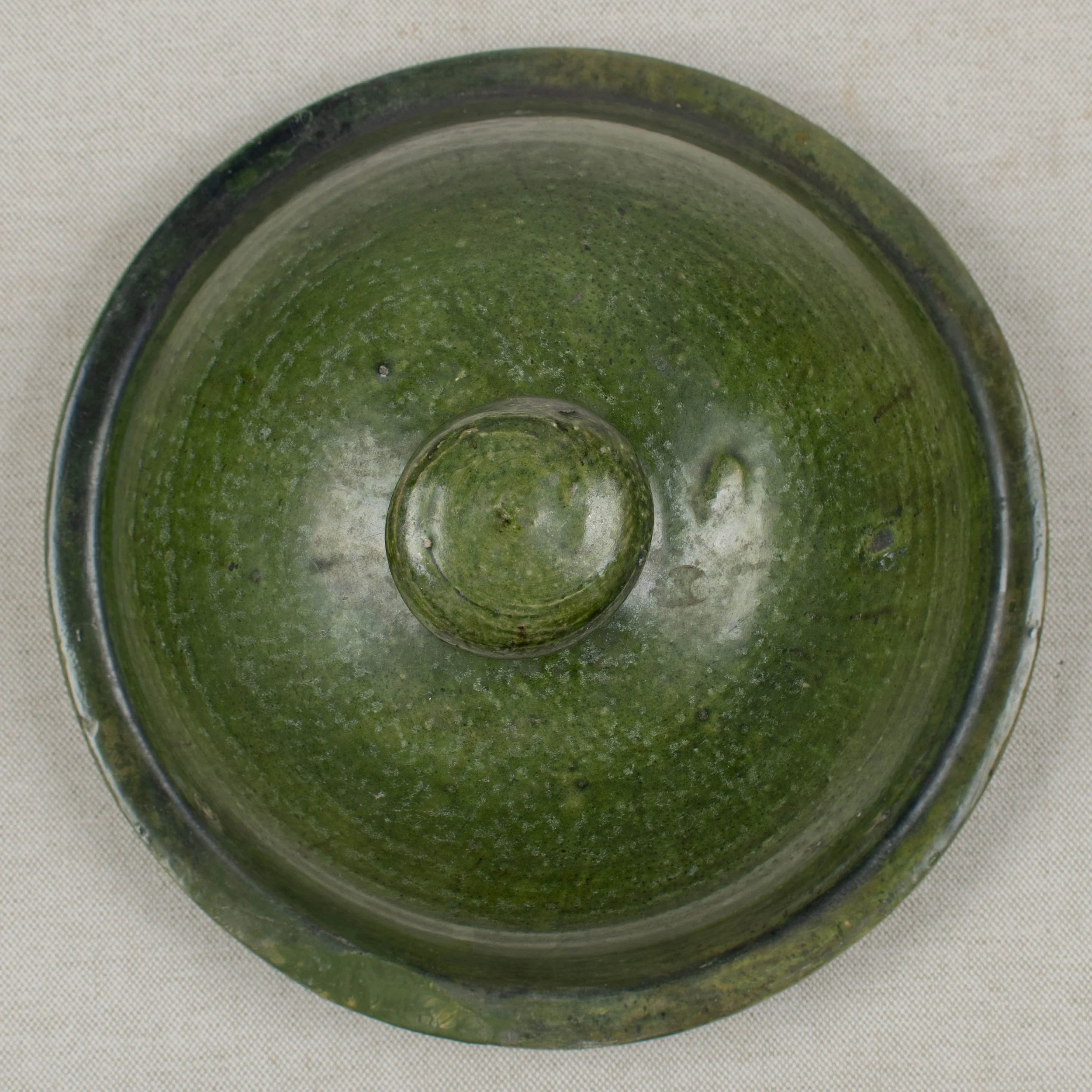 A large green glazed earthenware lidded jar made in Portugal