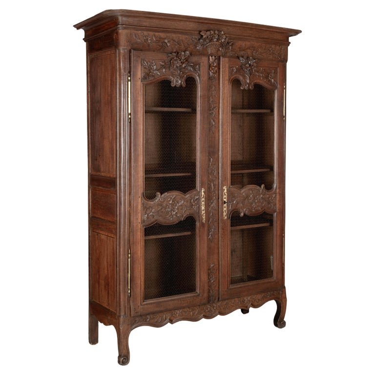 A 19th century Louis XV style Country French armoire, or display cabinet from Normandy.