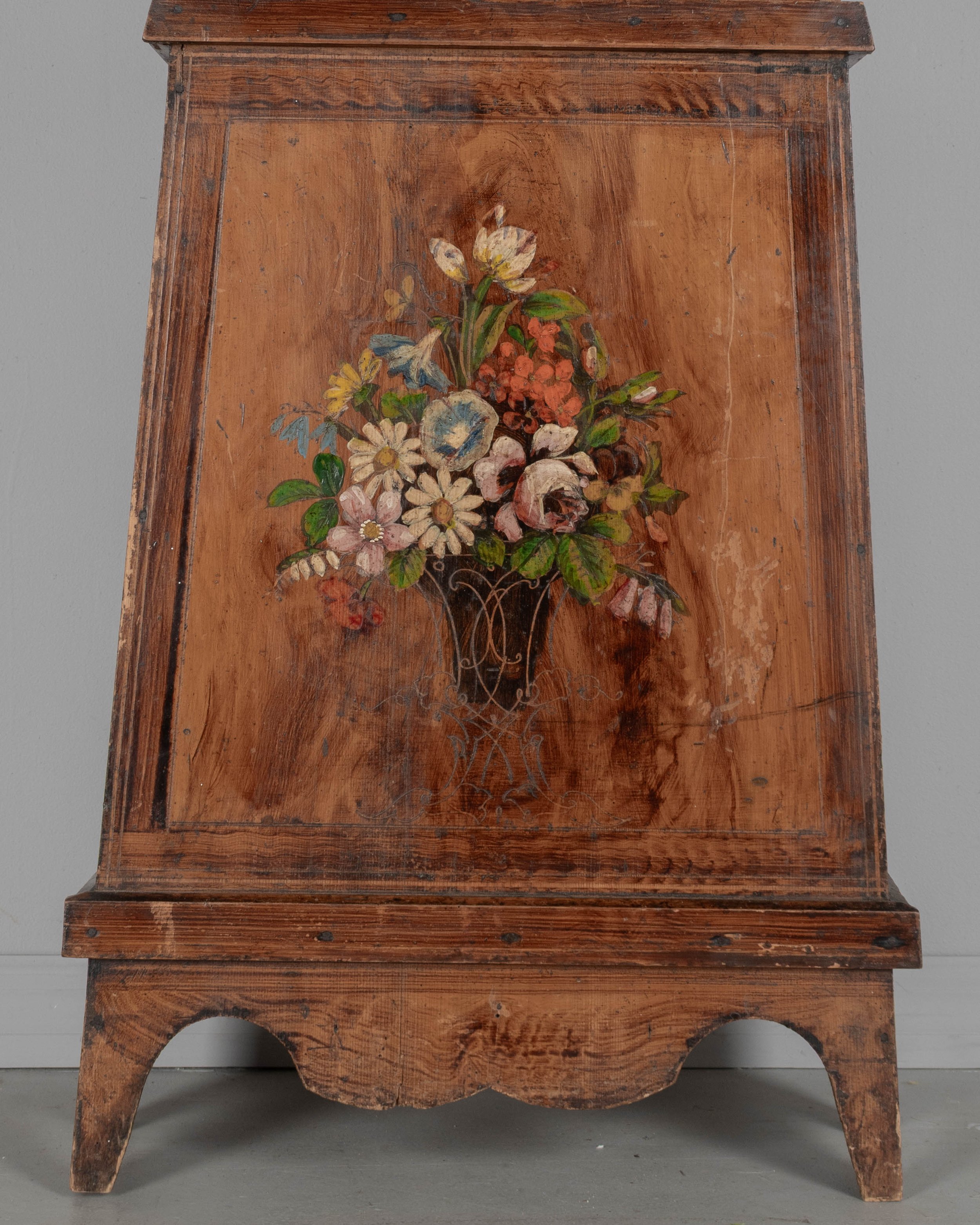 19th century Country French comtoise, or grandfather clock, with polychrome painted pine case and embossed brass pendulum.