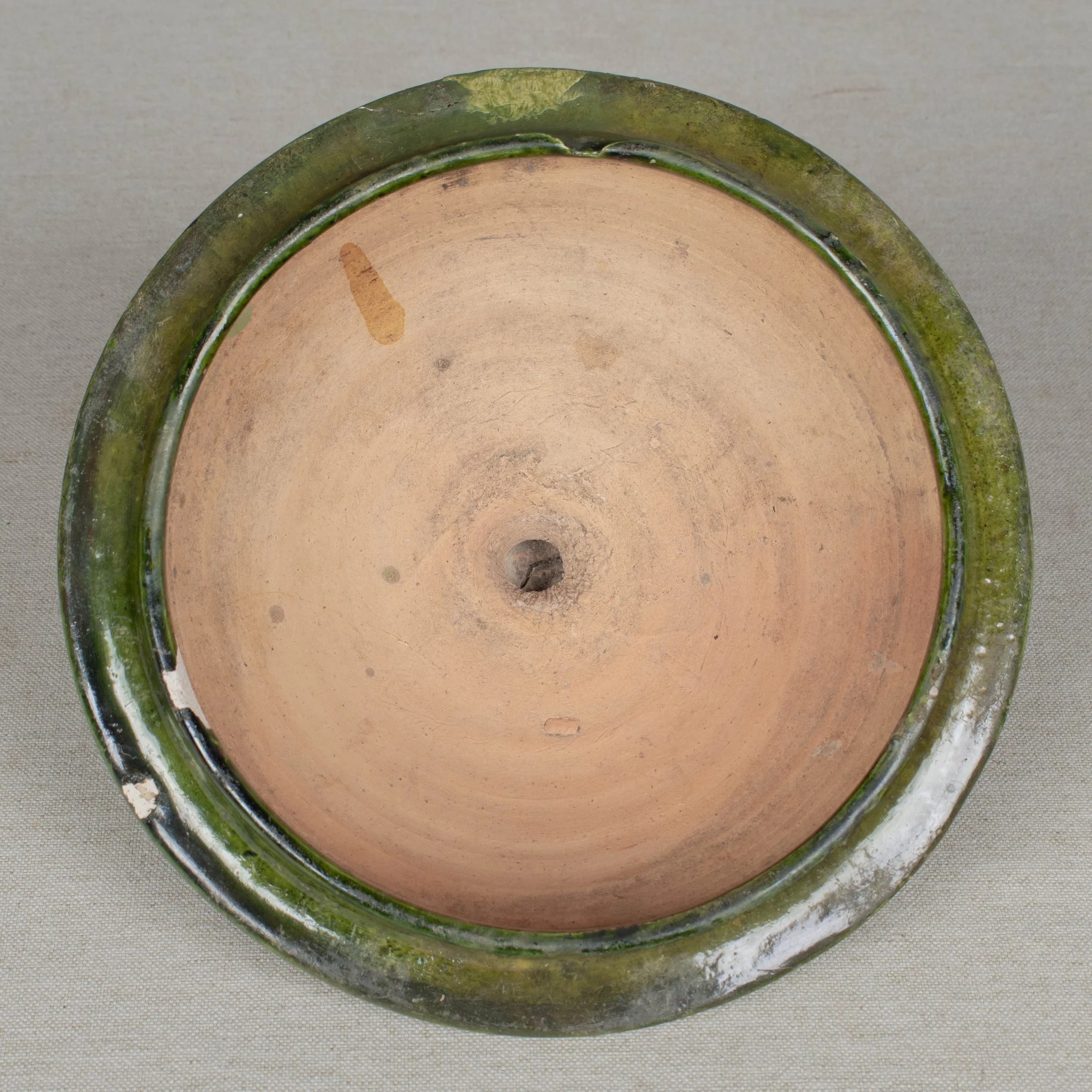 A large green glazed earthenware lidded jar made in Portugal