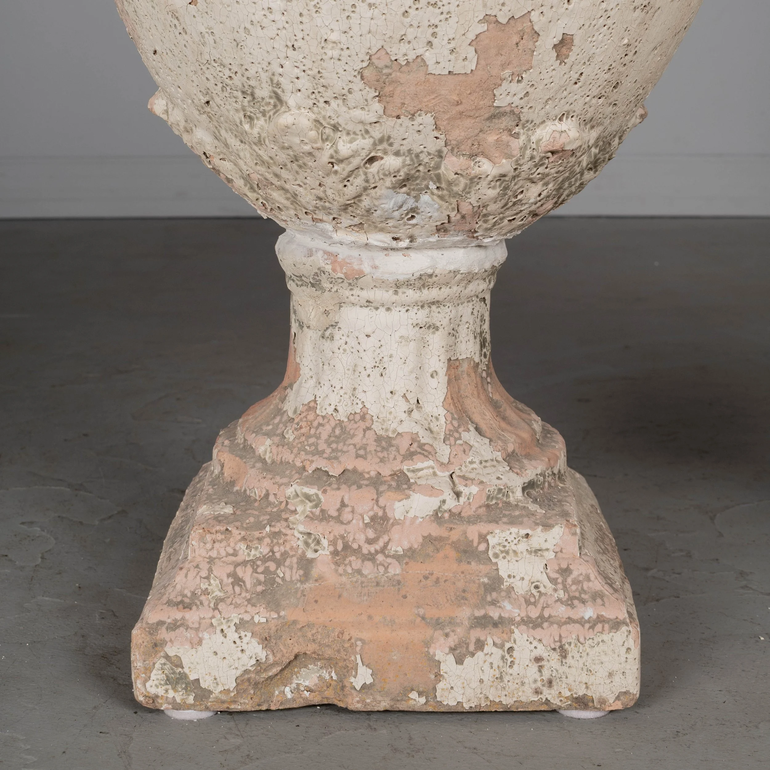 A pair of French terracotta garden urns with lids. Classical vase form on pedestal base, decorated in acanthus leaf motif with large acorn finials on lids.