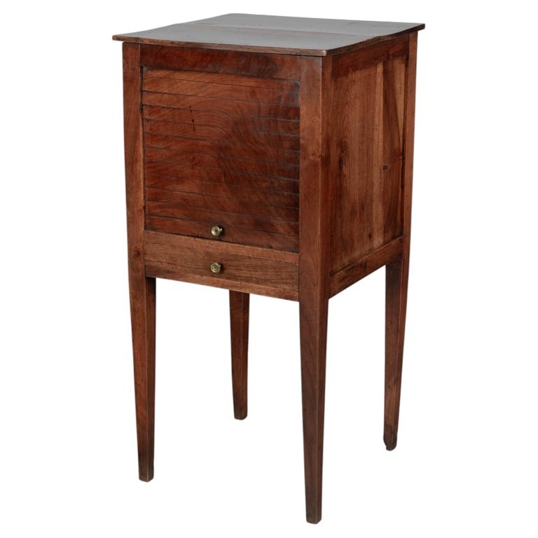 A 19th century French Country walnut side table, or nightstand, with a vertical tambour door above a slim dovetailed drawer