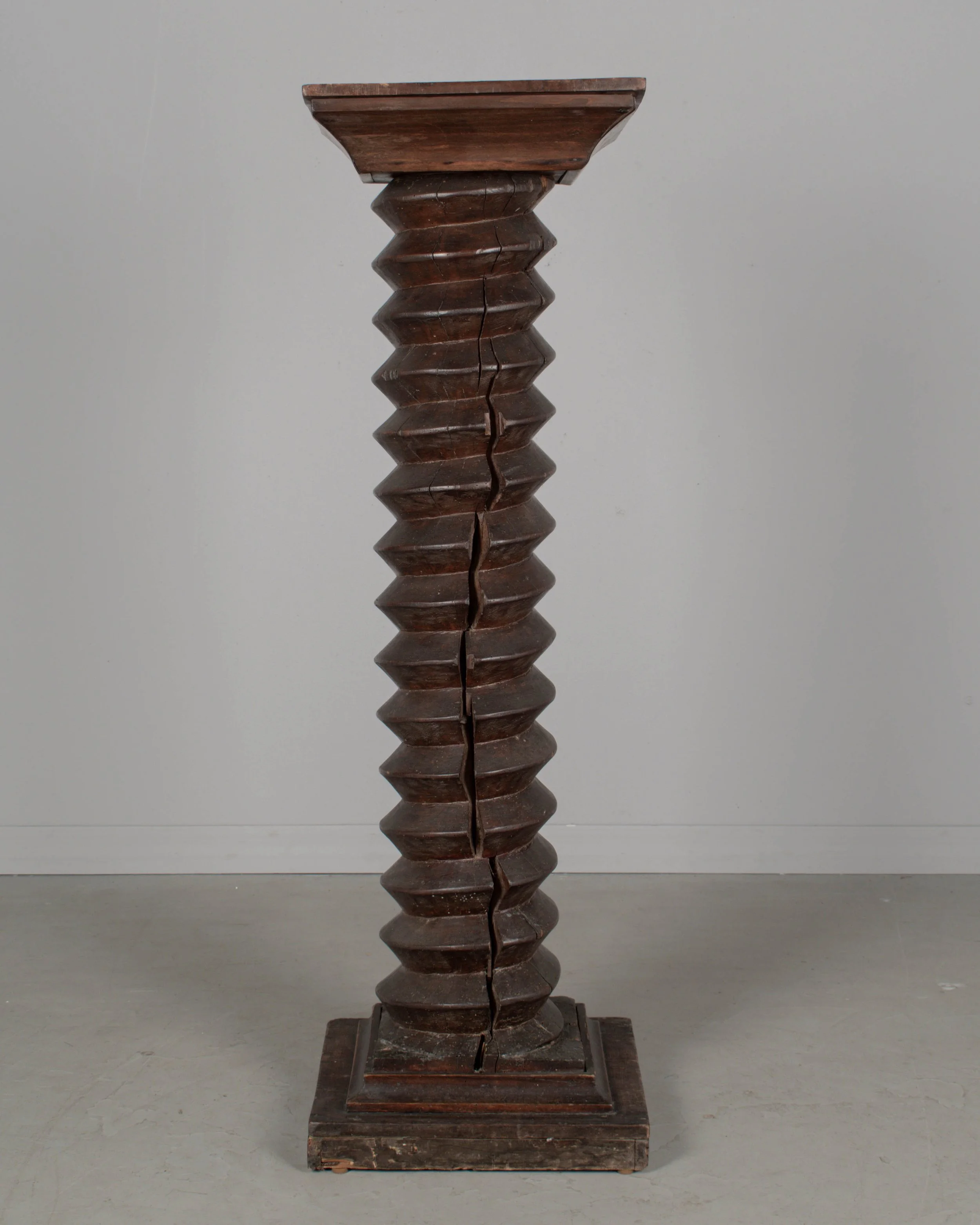 A late 18th century French wooden wine press screw, repurposed as a pedestal or plant stand