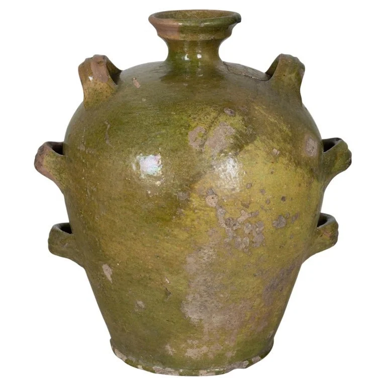 A 19th Century French green glazed pottery jug with ovoid form, short flared neck and looped handles. Beautiful rustic patina, minor glaze loss, chipped bottom