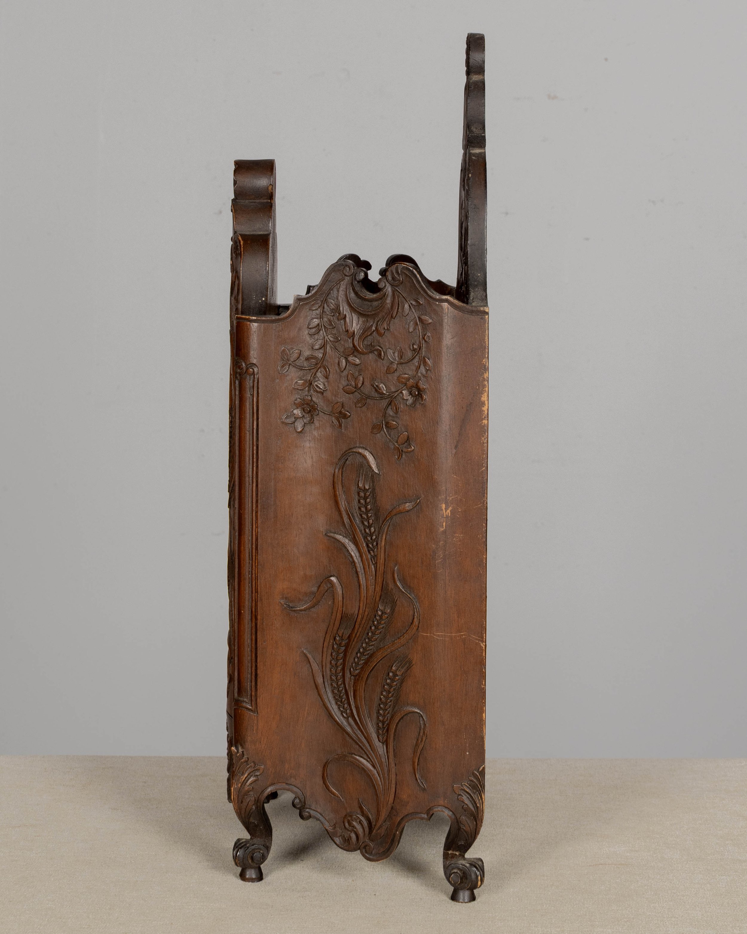 19th century French fariniere made of walnut with nicely detailed hand-carved decorative motifs: