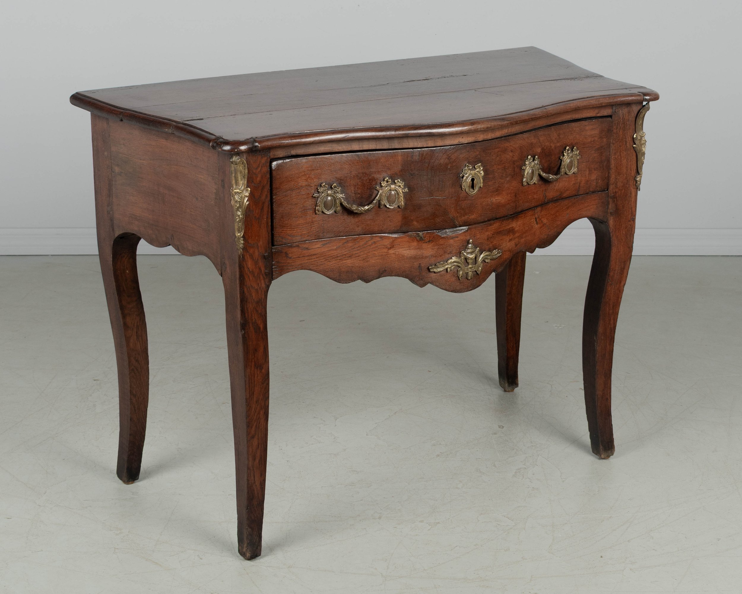 An 18th century Louis XV style French Provençal console table with serpentine front,