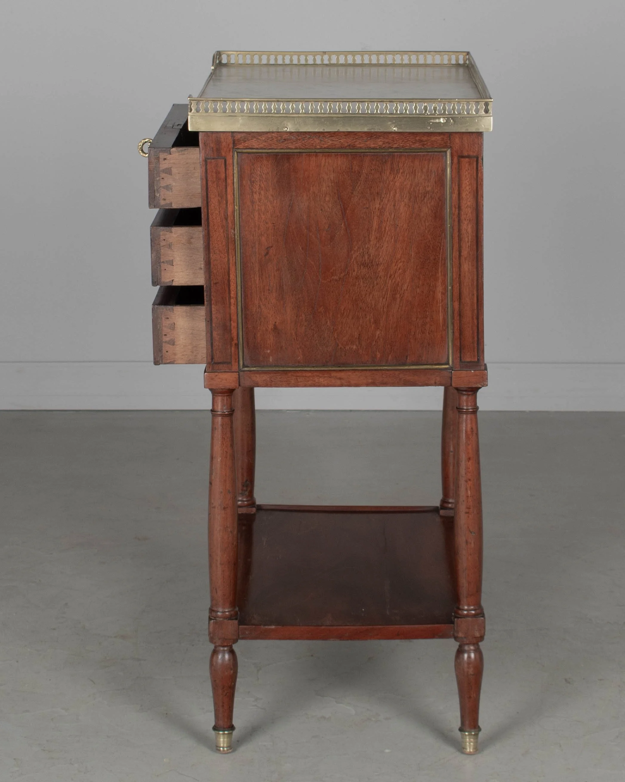 A 19th century French Louis XVI style marble top nightstand, or side table, made of veneers of mahogany with solid oak as a secondary wood