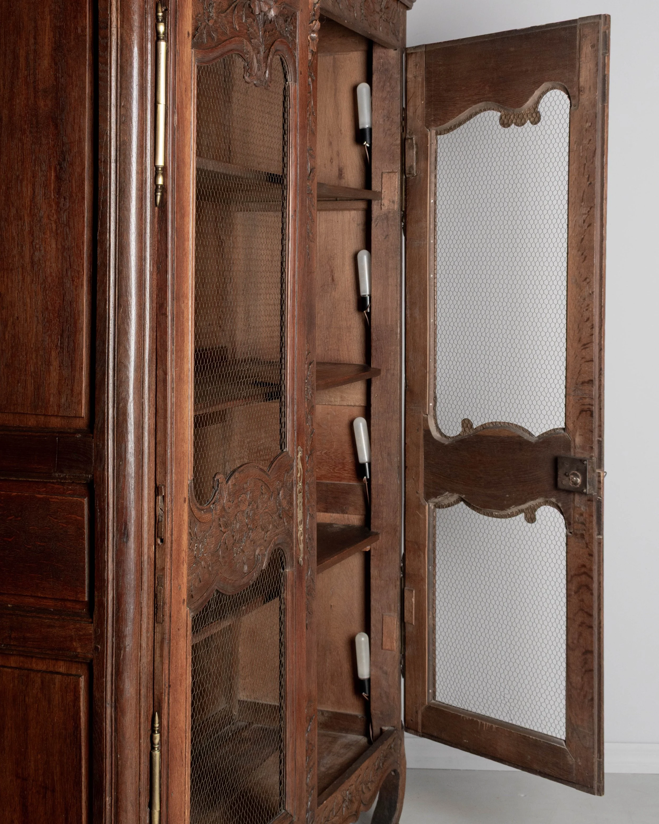 A 19th century Louis XV style Country French armoire, or display cabinet from Normandy.