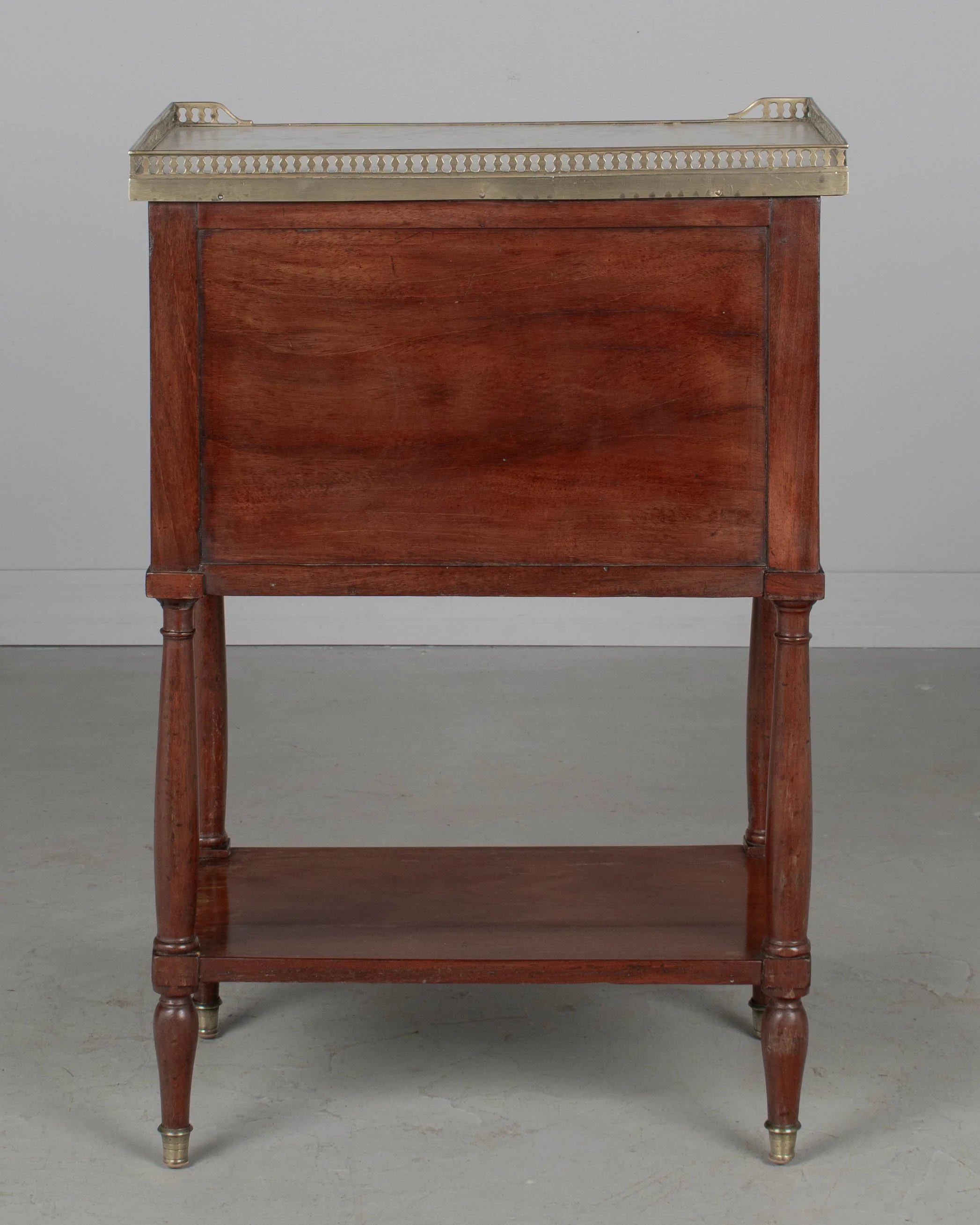 A 19th century French Louis XVI style marble top nightstand, or side table, made of veneers of mahogany with solid oak as a secondary wood