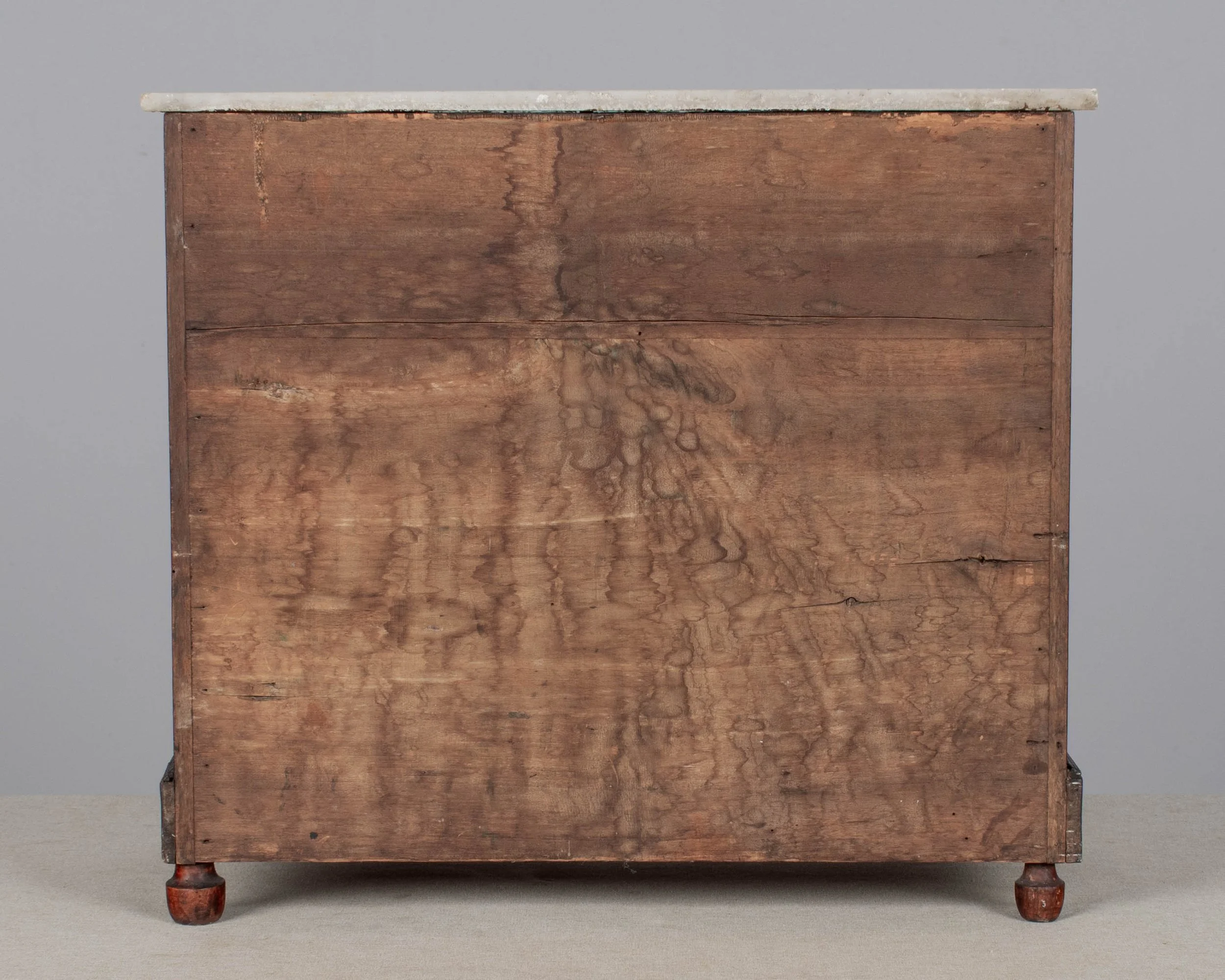 A 19th century Louis Philippe miniature sample commode made of mahogany with French polish finish. Four dovetailed drawers with turned knobs and escutcheons