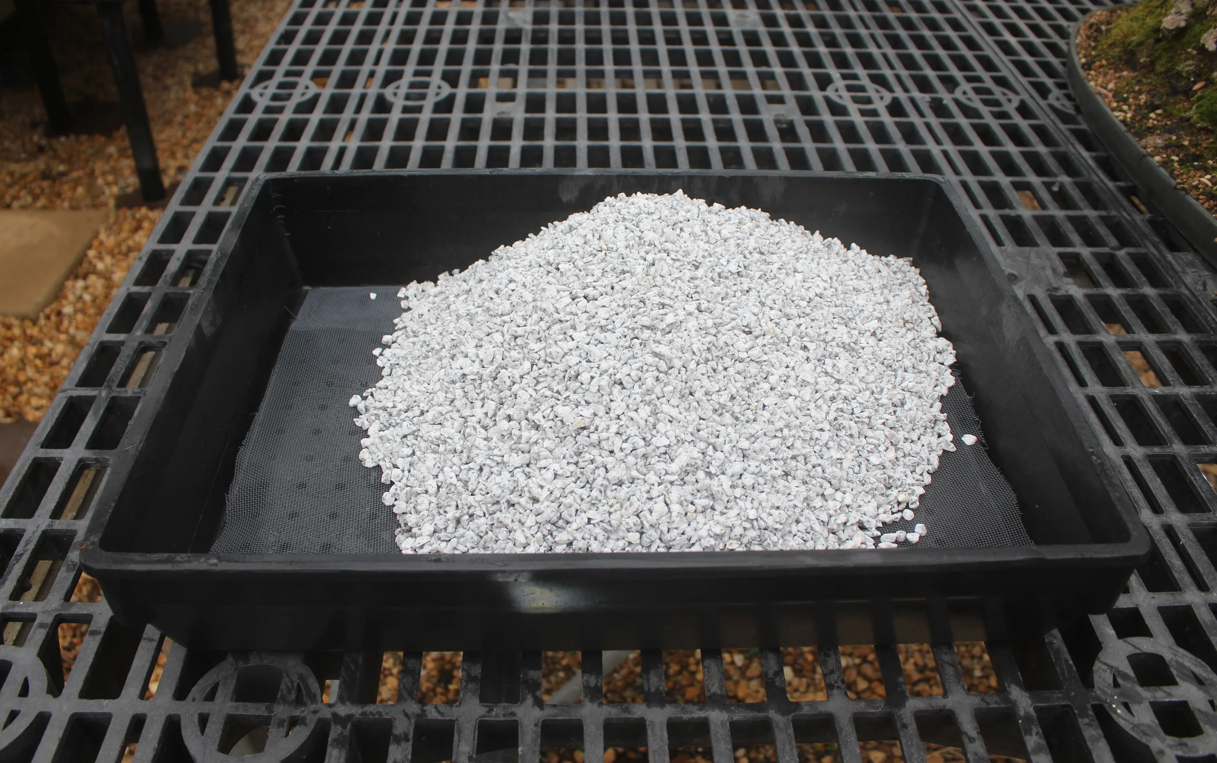 Place the crushed granite over the screen.