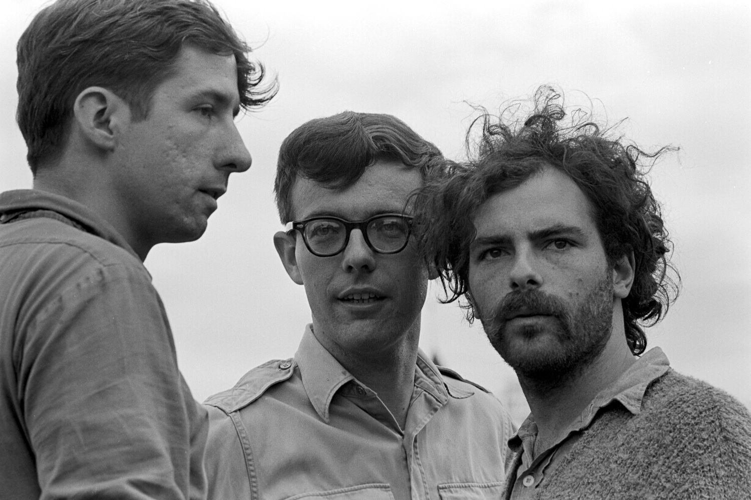  Tom Hayden (left), Rennie Davis (center) and Jerry Rubin (right) put their heads together in the open air at Lincoln Park. 