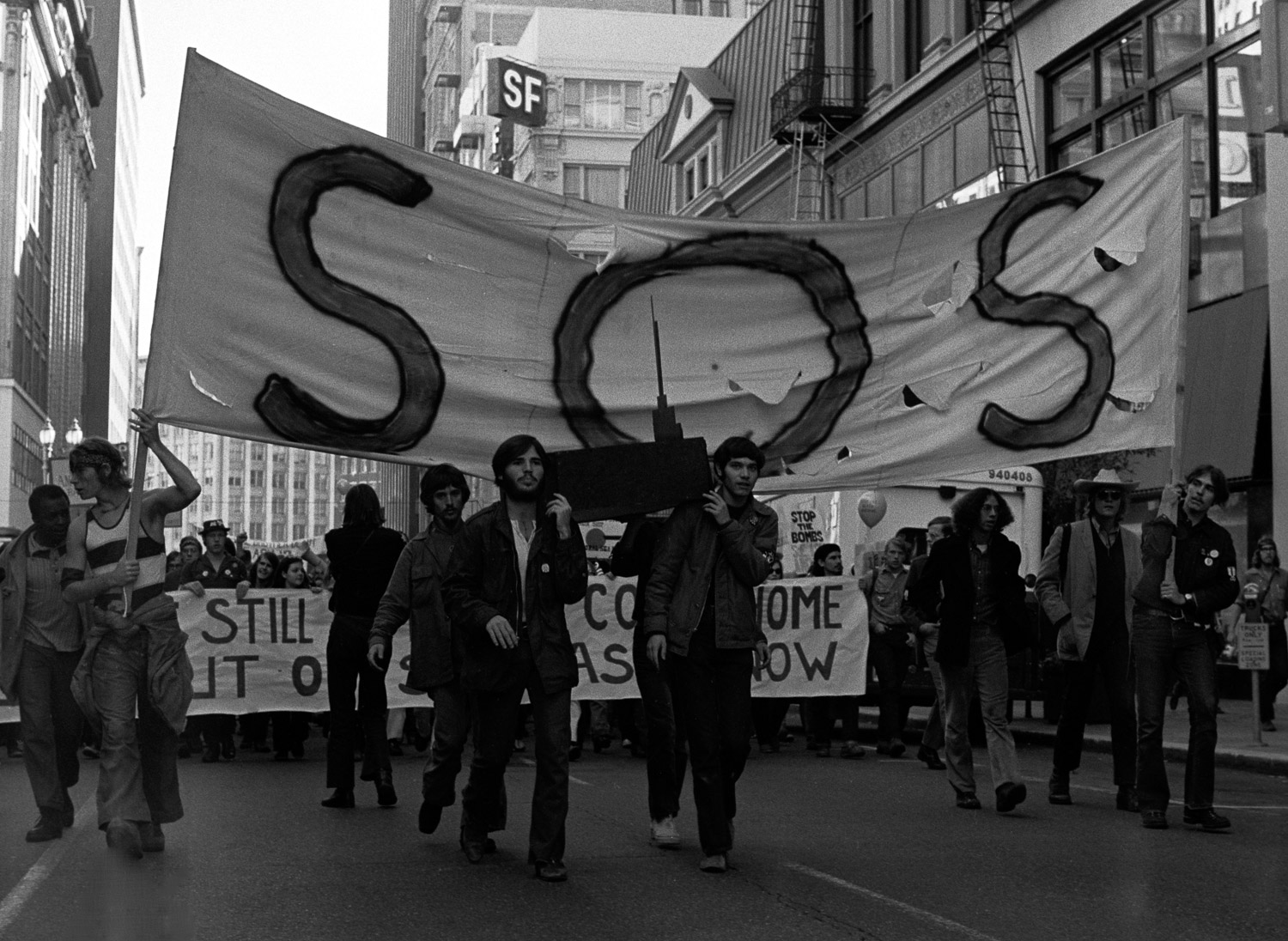 Some of the leaders of the Stop Our Ship movement are marching down Market Street, at the front of a peace march on Nov. 6, 1971. They are carrying a wooden model of the aircraft carrier USS Coral Sea on their shoulders like a coffin.
