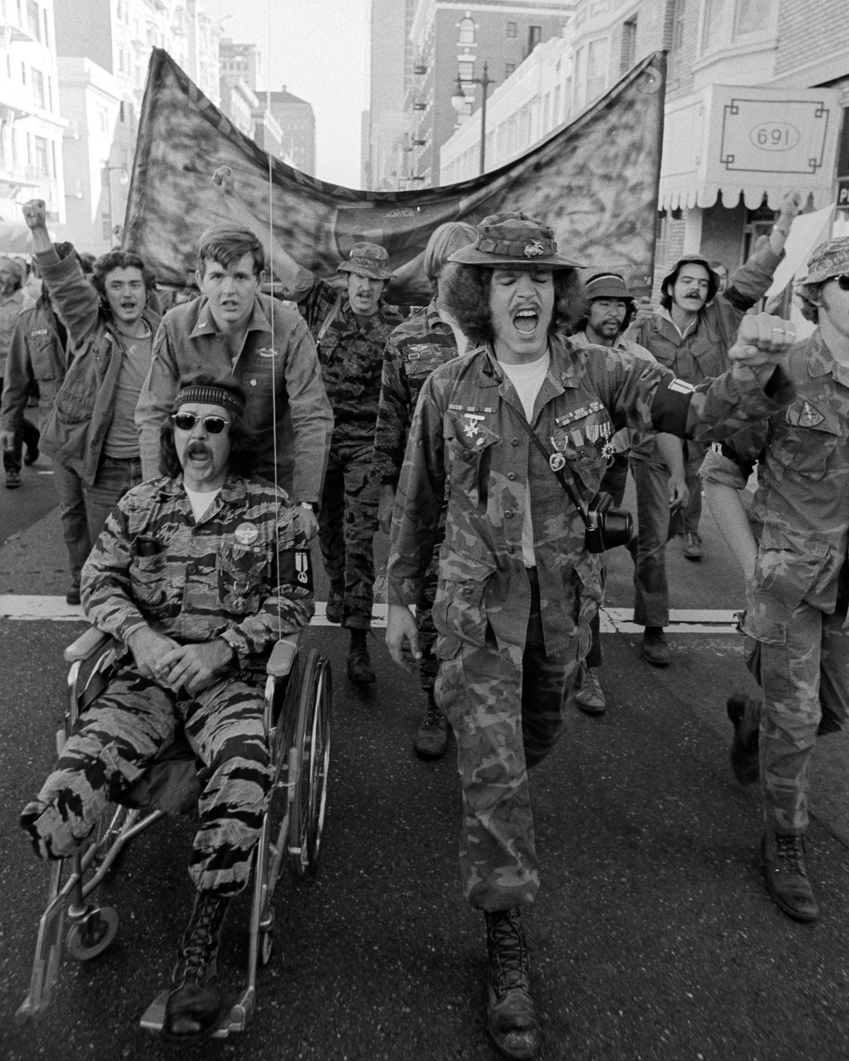 A contingent of veterans joins the march in support of the USS Coral Sea sailors movement to stop their ship from sailing to Vietnam.