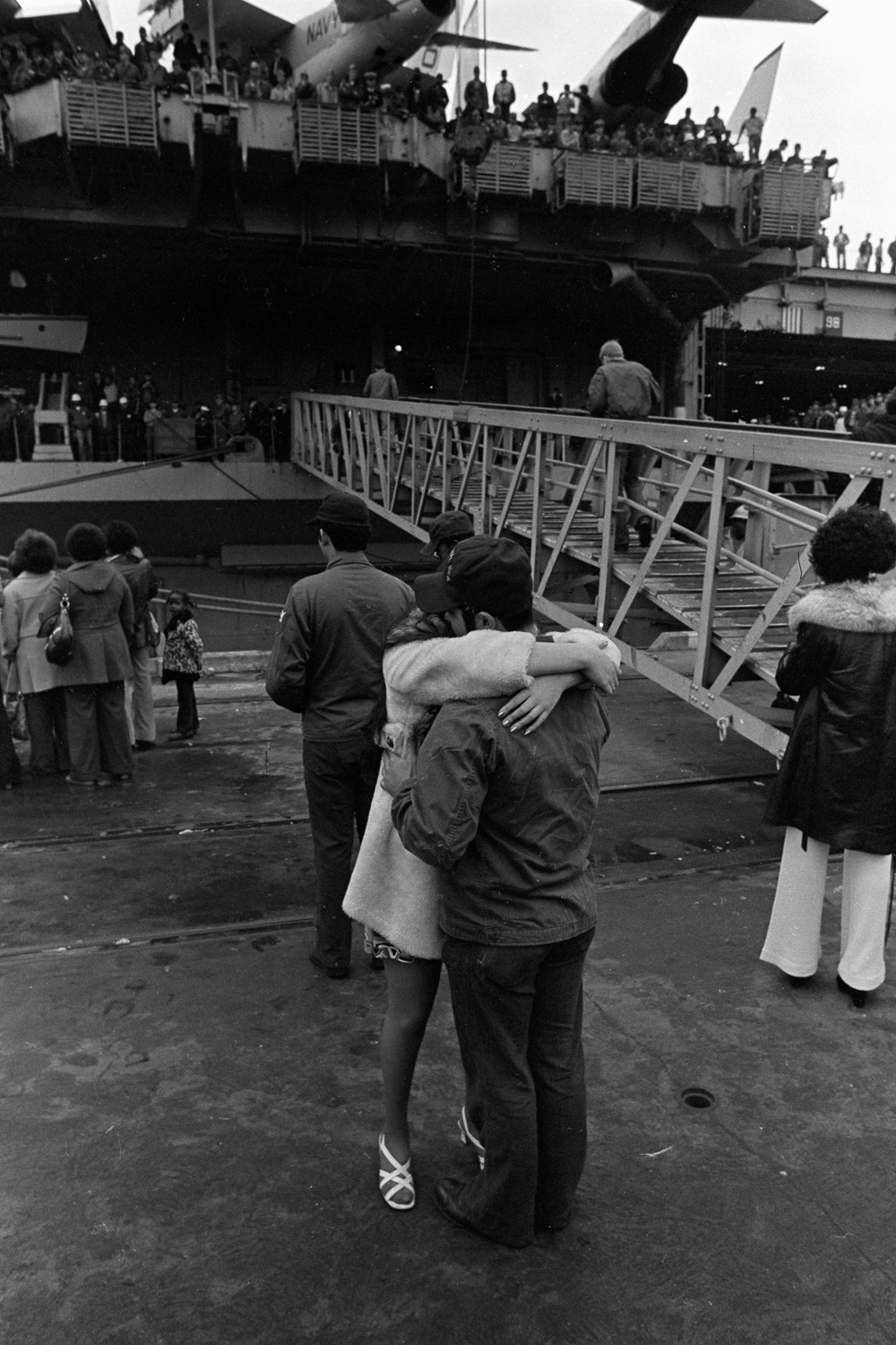  A sailor and his girlfriend enjoy one last hug before he sails aboard the USS Coral Sea. 