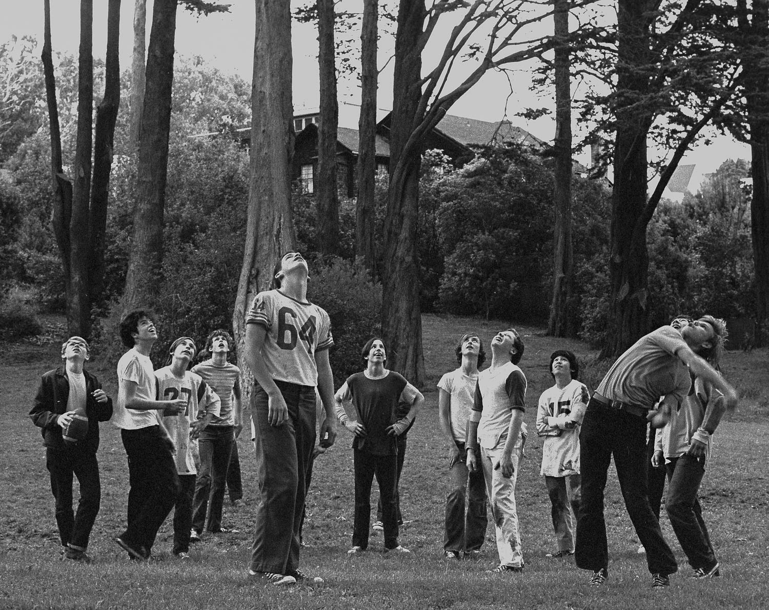 Boys throwing a football as high as they can, in a park on Lake Street in San Francisco's Richmond district.