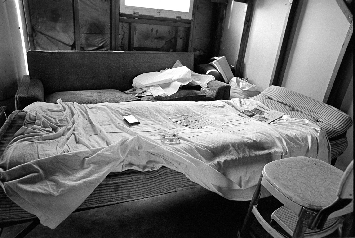 Cards on the bed. No blanket. No pillow. No interior wall. Not close to a standard of decency most of us would expect.
