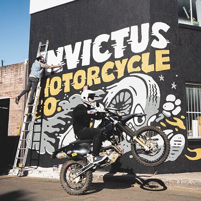 Process photo of the mural artwork going up at the new @sol_invictus_moto Alexandria service &amp; showroom. Their signature tyre-man with some big rad lettering.
Featuring @_adriankorner popping it up on one wheel. 
Photo by @yeahradcreative.
-
www.