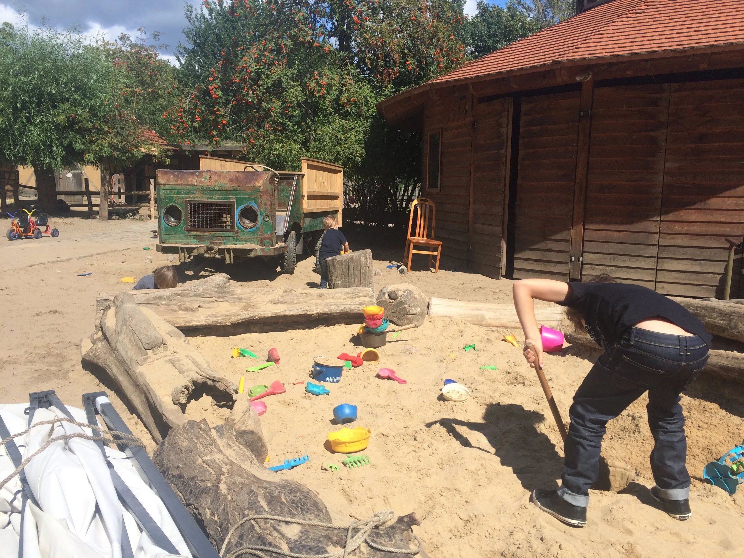 this is me making a trap hole. There are some kids my age making a huge tree houses. They has saws and nails. hugo loves going on the old rusty truck.i love playing soccer there and i sometimes I miss.