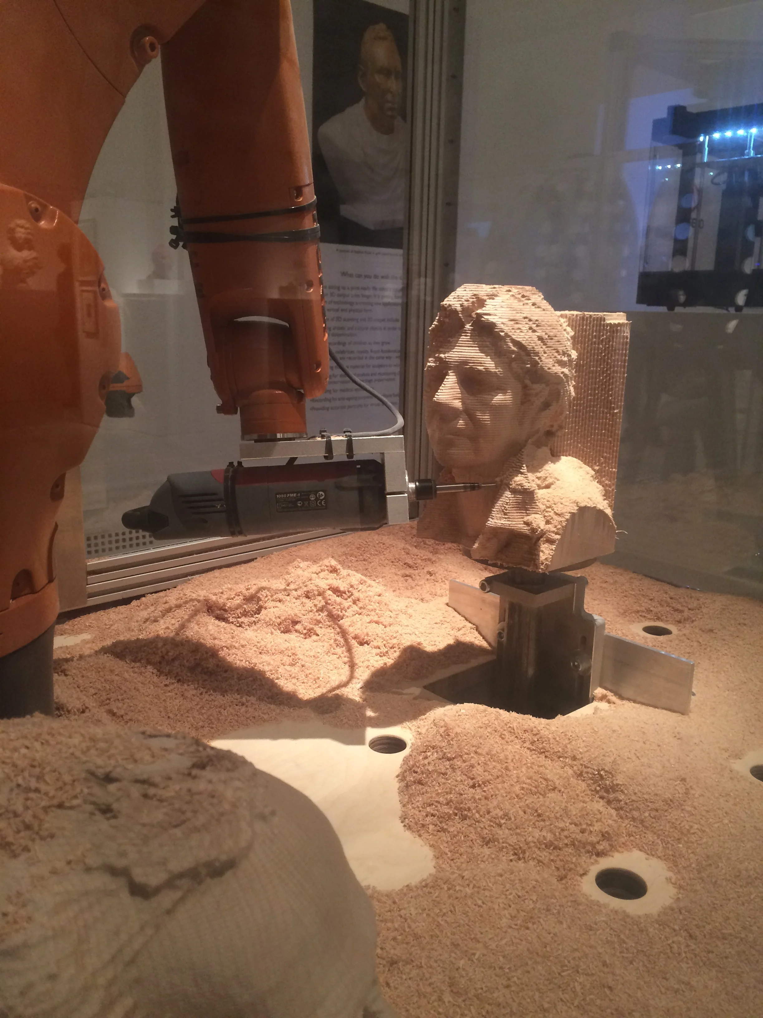 this is a robot that made sculptures it is awesome. the robot looks at your face and it copy's your face on to the wood. So it was really cool.