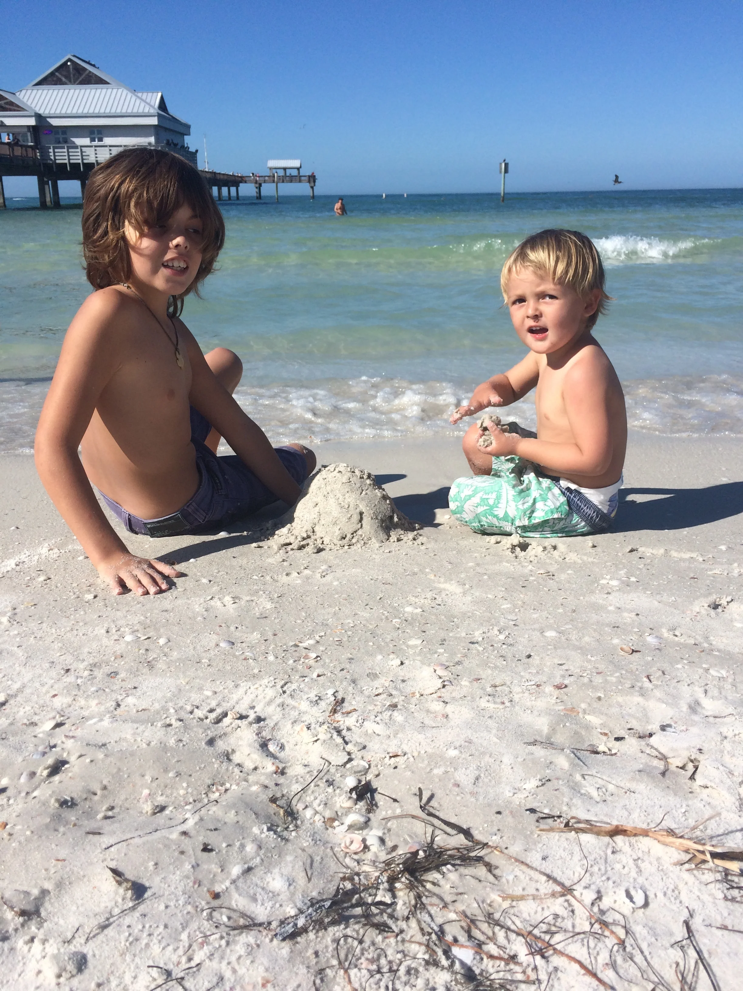 we wanted to go to our friend Debby but first we went to this beach called Clearwater beach and i made a sand castle for Hugo then i picked up some sea shells for mum .
