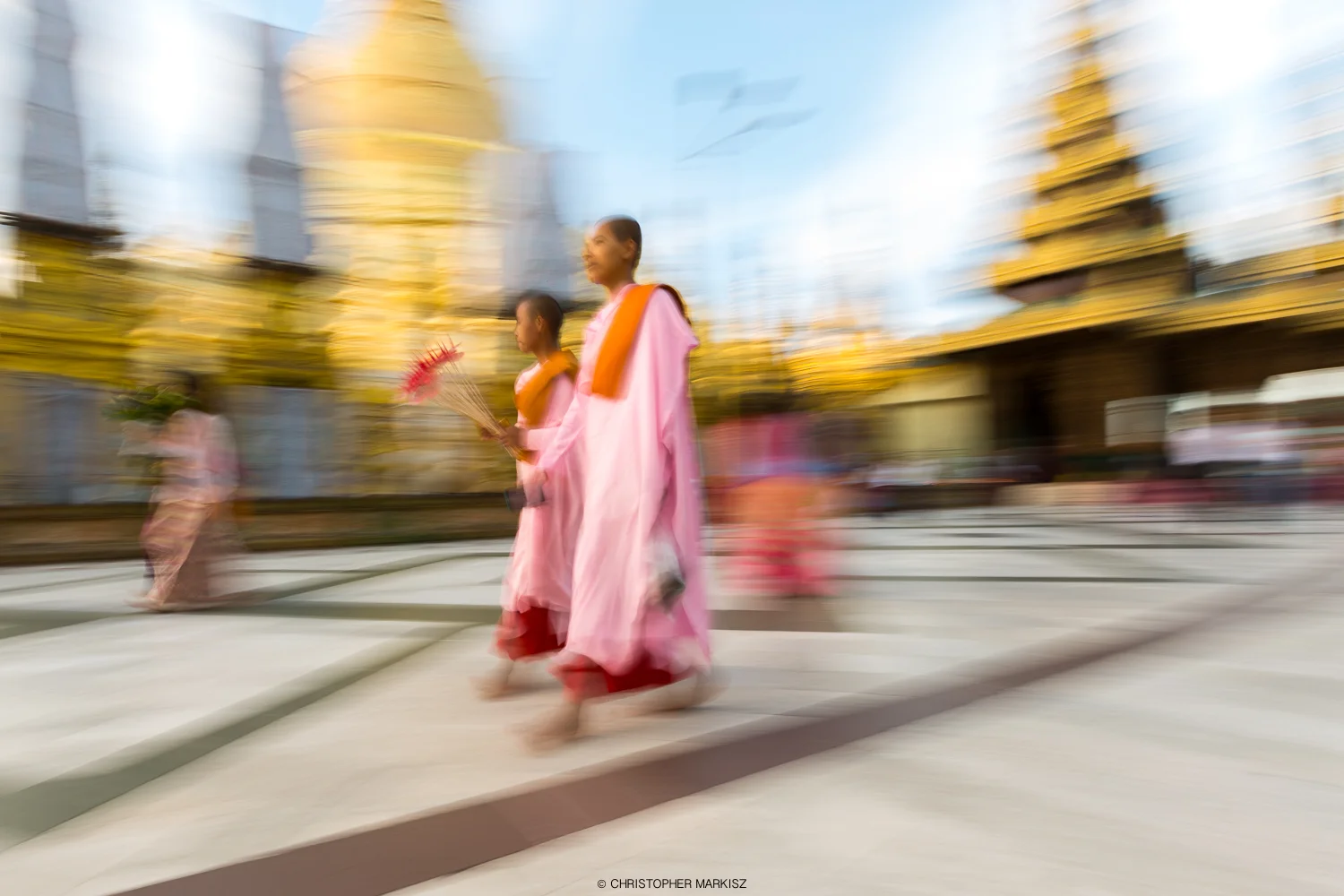 Buddhist nuns panned while walking at Shwedagon Pagoda. Yangon, Myanmar.