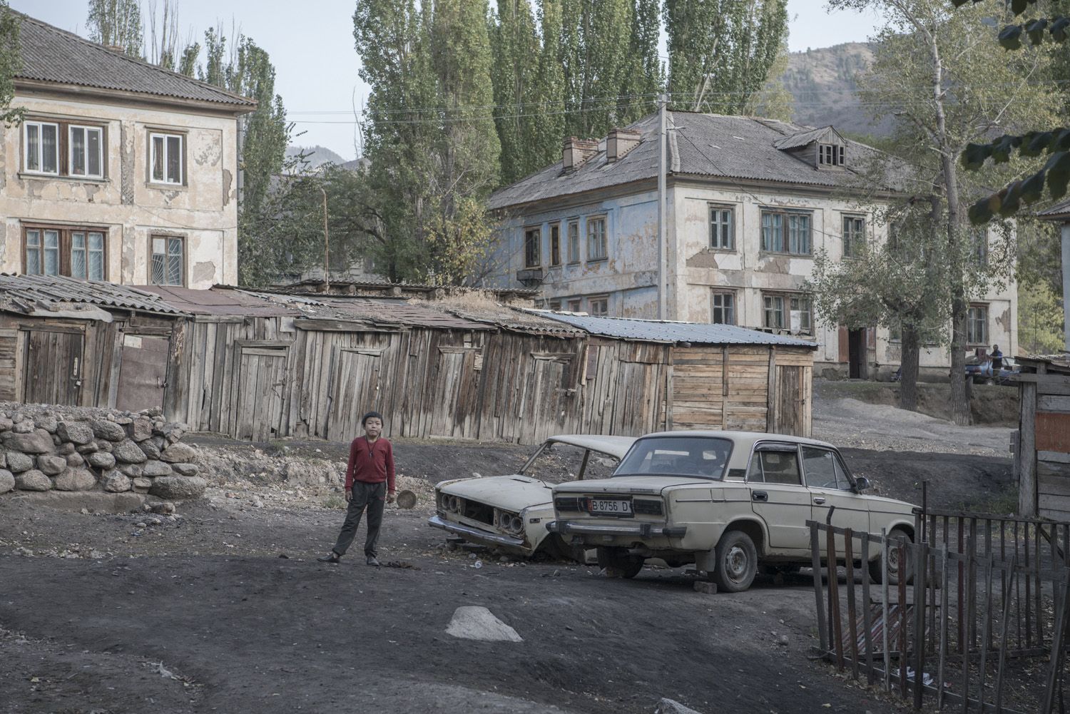 boy-ladas-abandoned-min-kush-soviet-uranium-mining-town-industrial-Russia-Kyrgyzstan-ruins-soviet-sign-jo-kearney-photos-video-photography.jpg