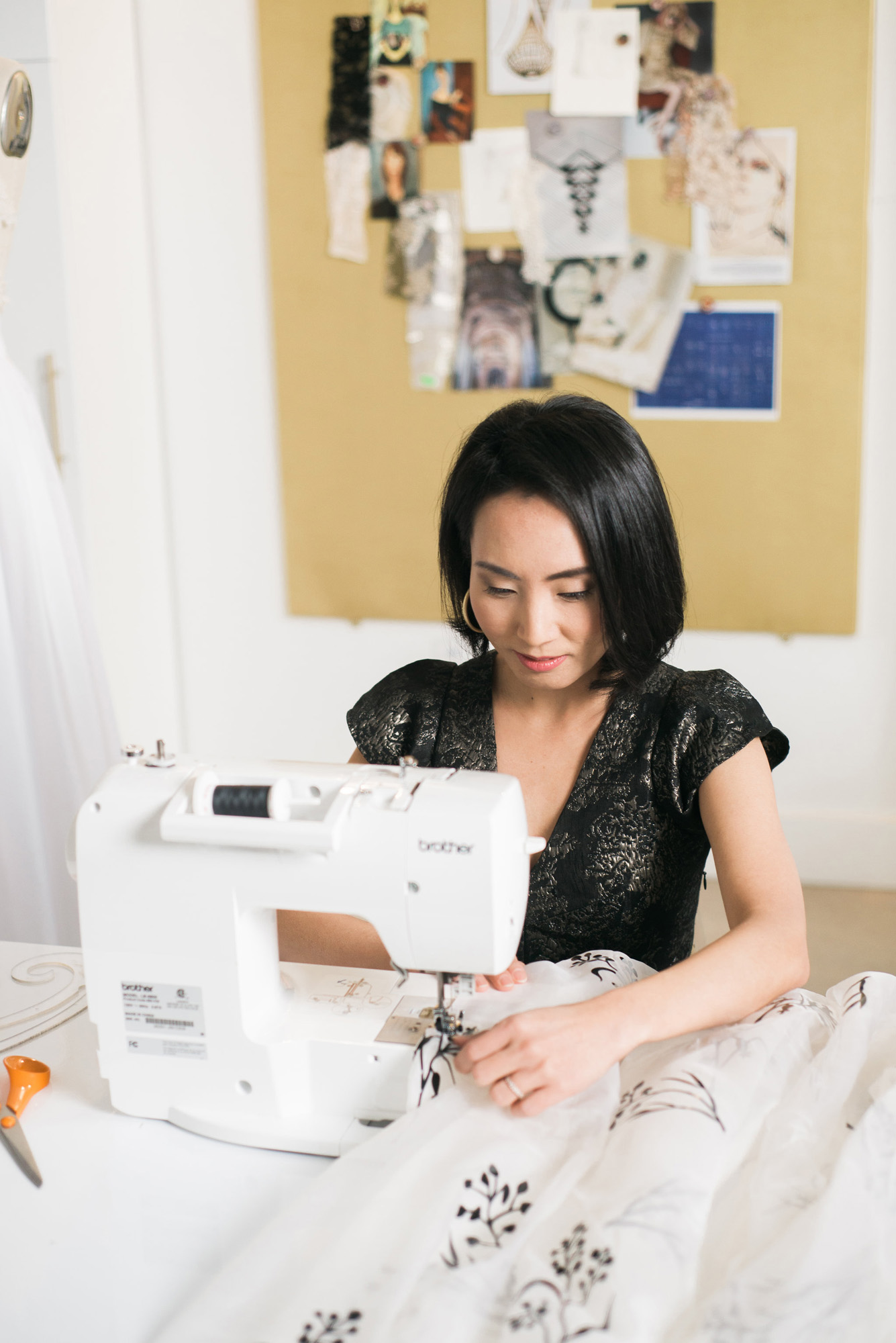 Angela Kim of Asheville Couture at sewing machine | Photography by Sarah Hooker Photography