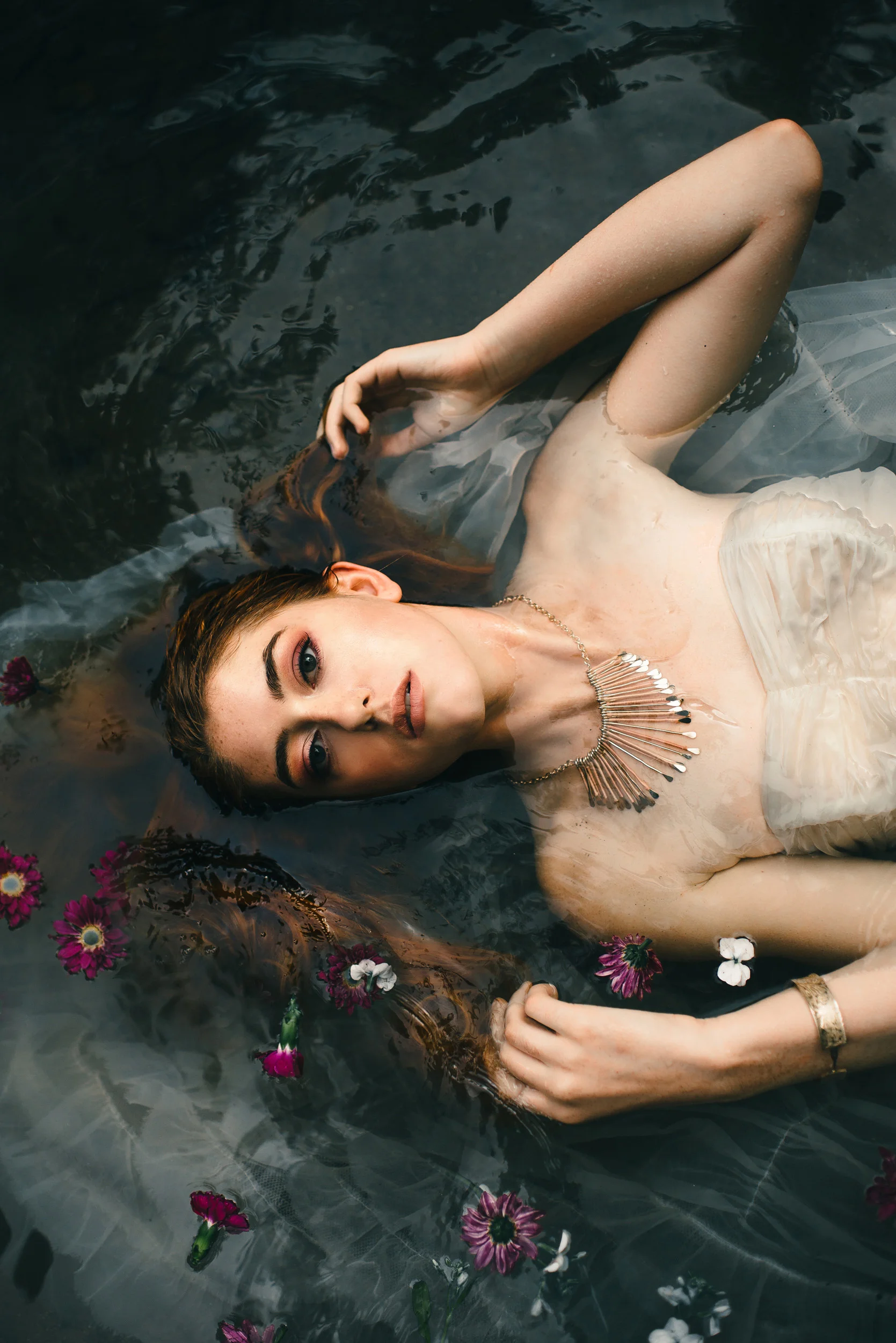 White vintage dress in the water with flowers by Sarah Hooker Photography